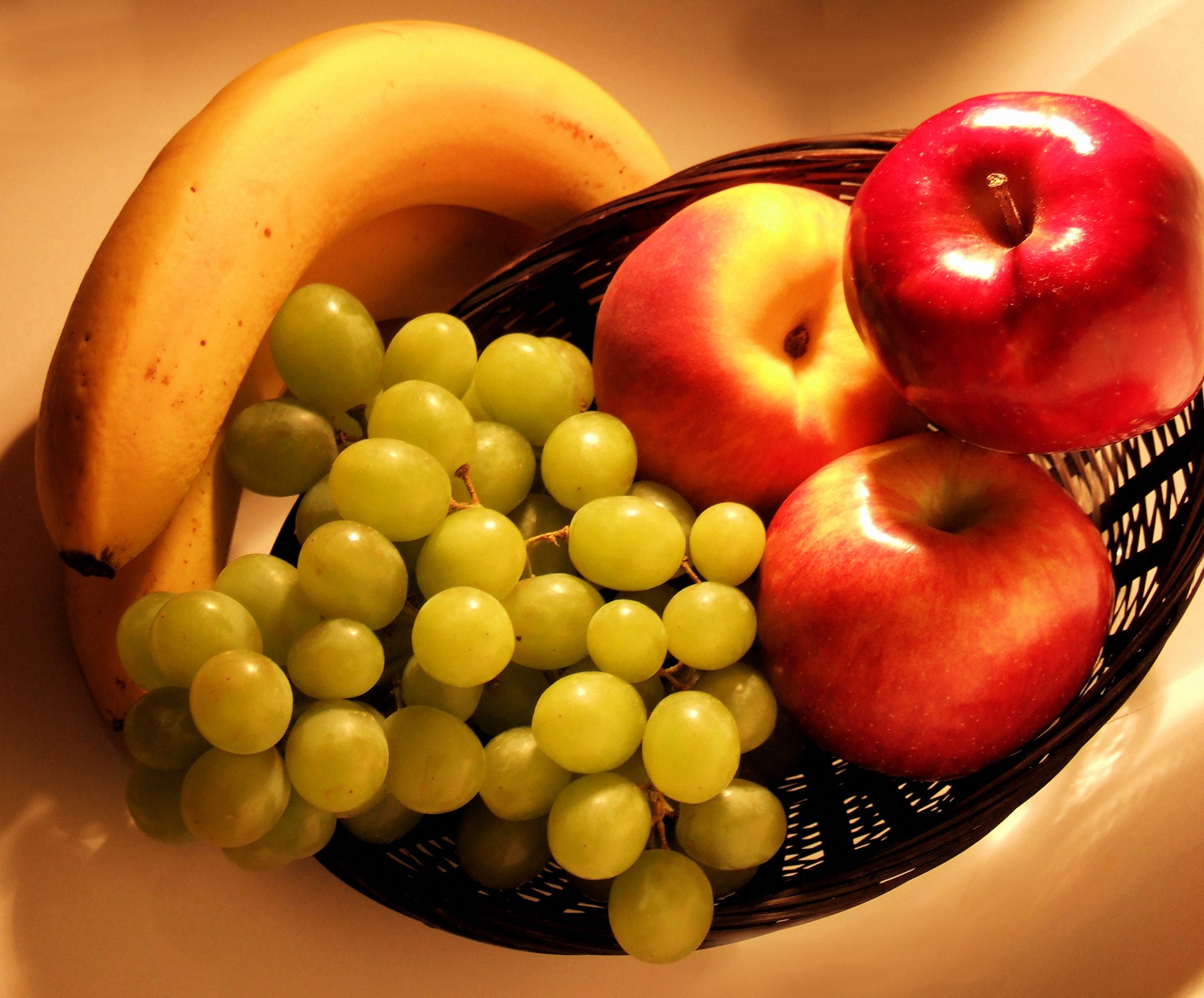 Fruit basket with bananas, apples, and grapes HD Wallpaper