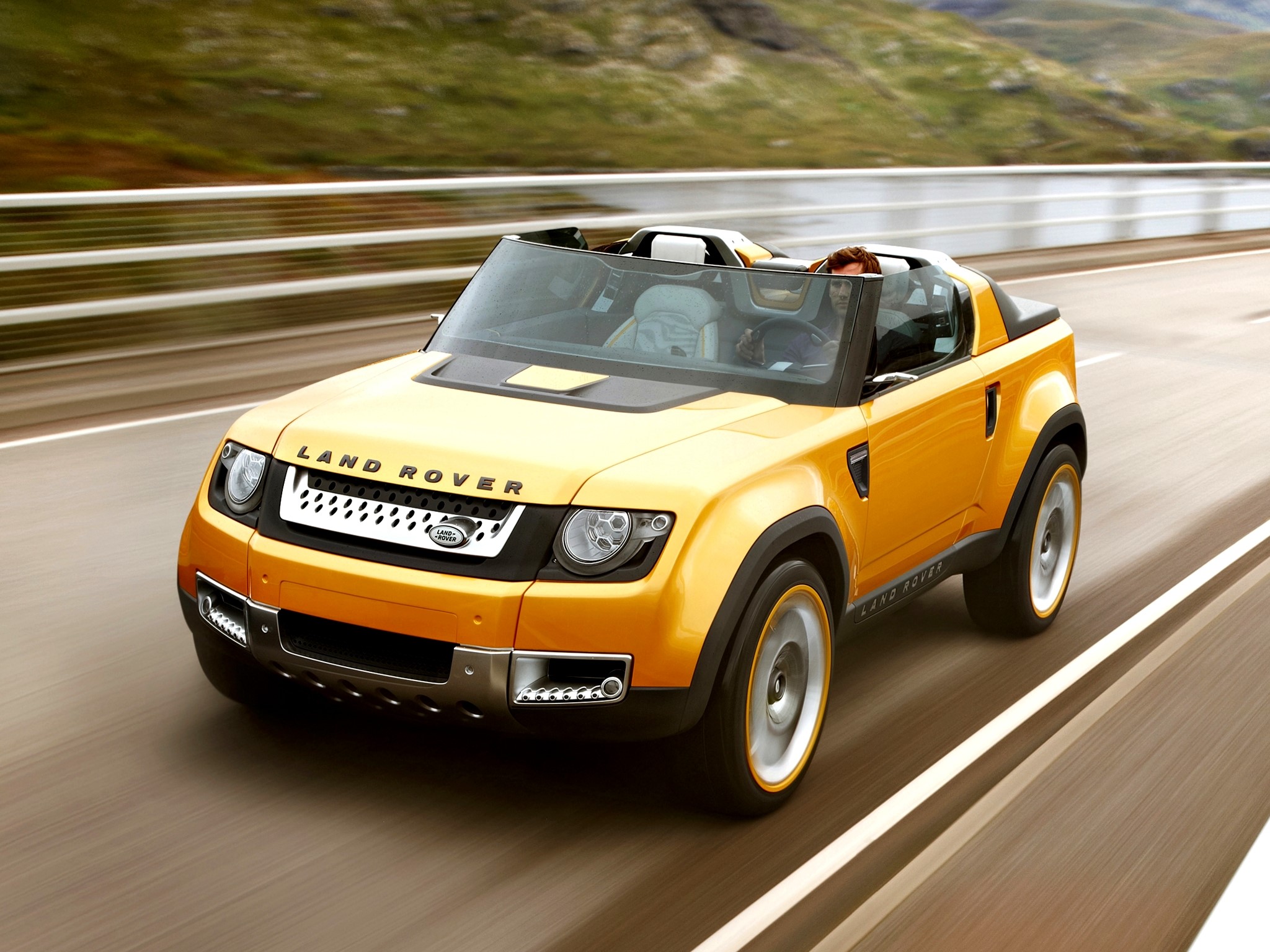 Yellow Land Rover convertible driving on a road HD Wallpaper