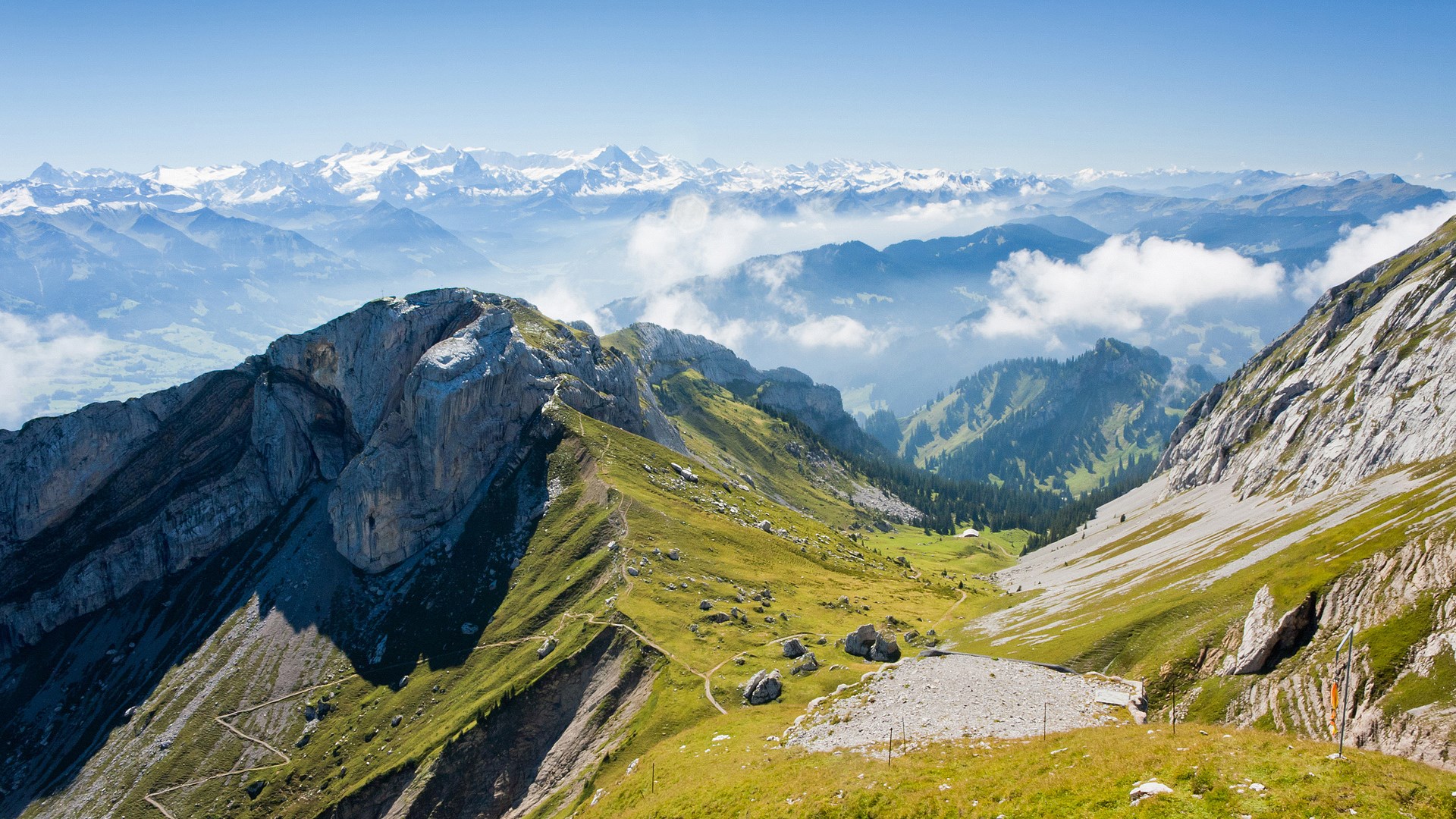 Panoramic view of the Swiss Alps with a hiking trail HD Wallpaper
