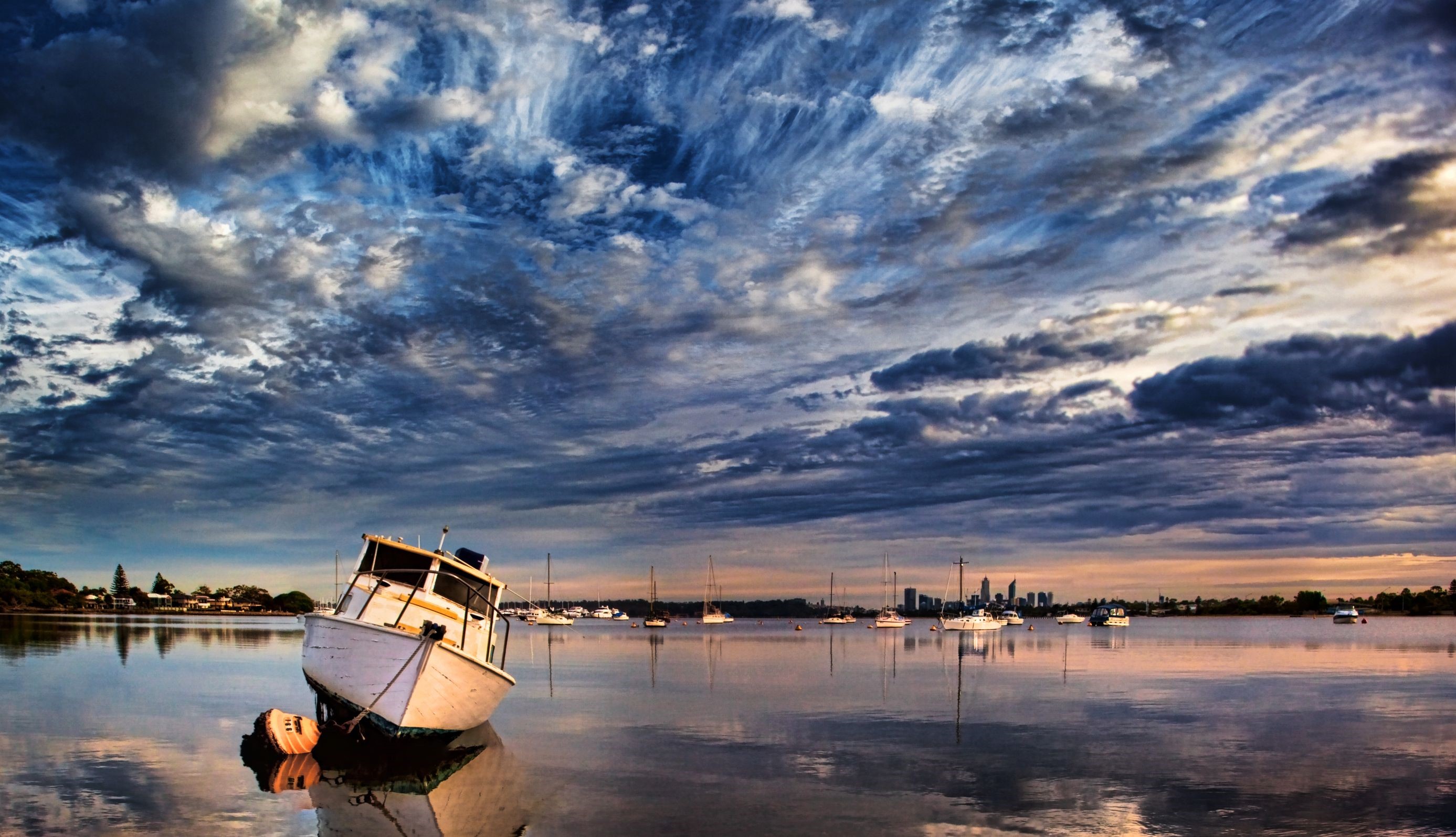 Boats on a calm bay under a dramatic sky HD Wallpaper