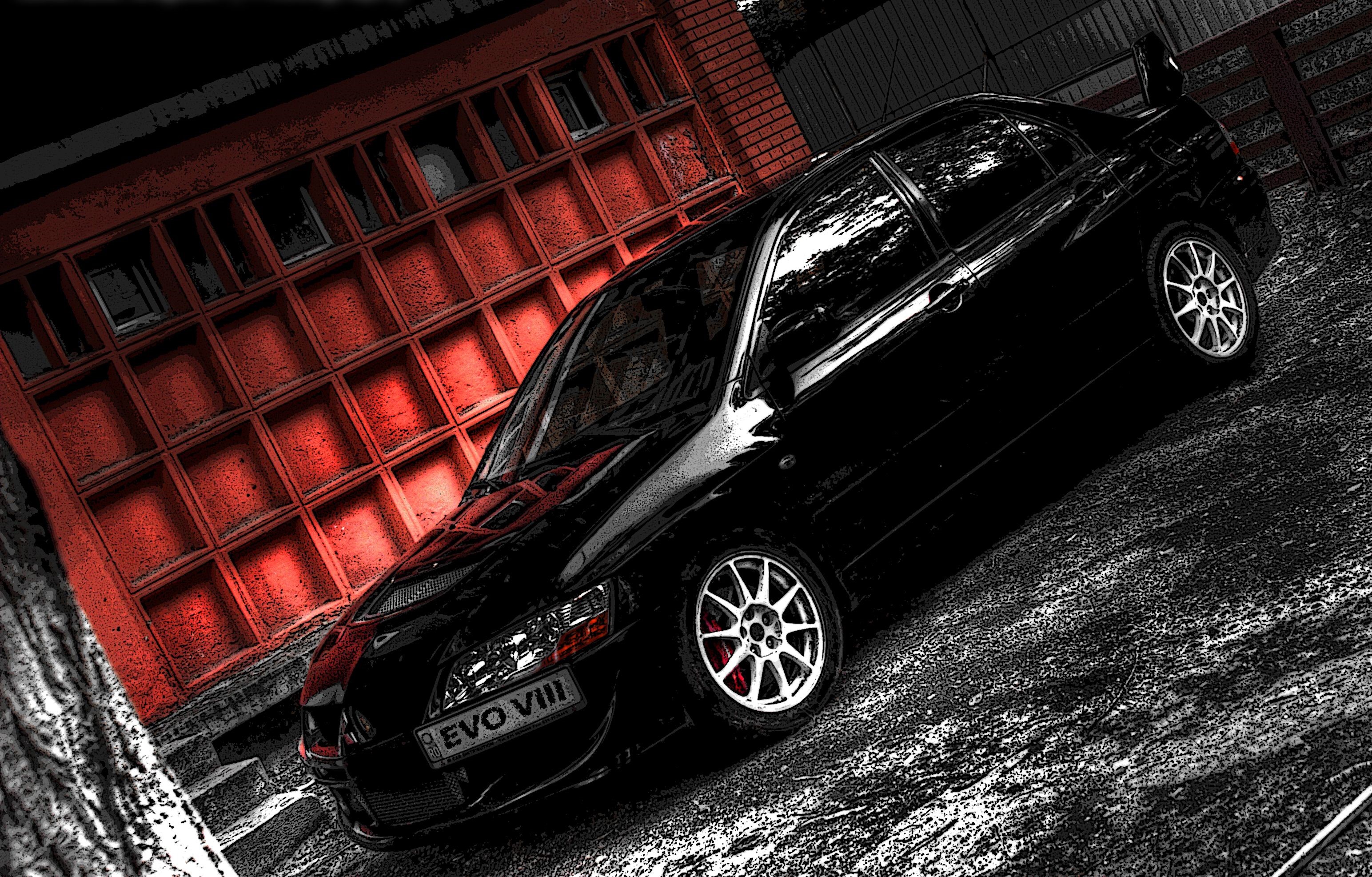 Black Mitsubishi Lancer Evolution VIII parked near red building HD Wallpaper