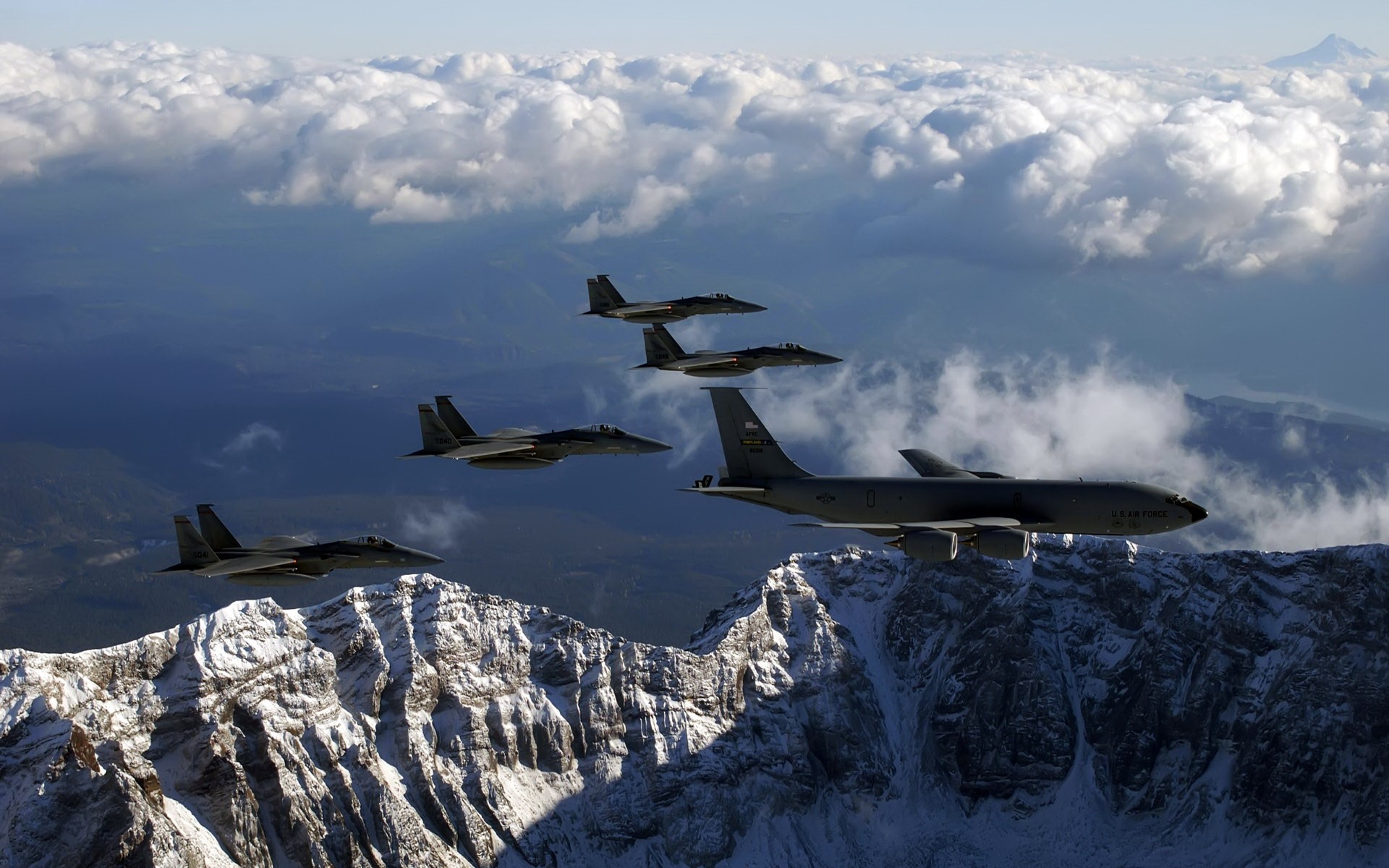 US Air Force F-15 fighter jets and KC-135 tanker fly over mountains HD Wallpaper