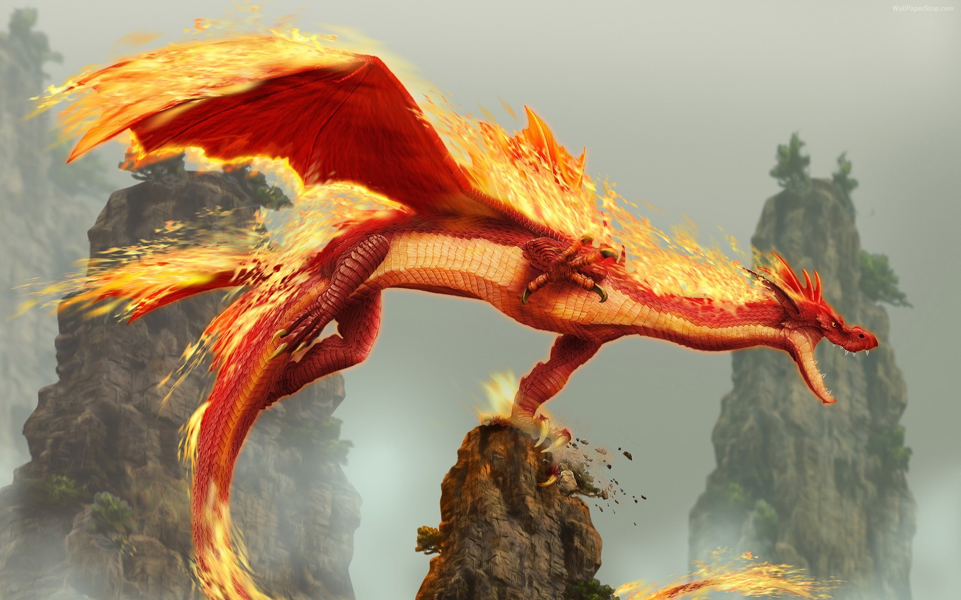 A fiery red dragon perched on a rocky outcrop HD Wallpaper