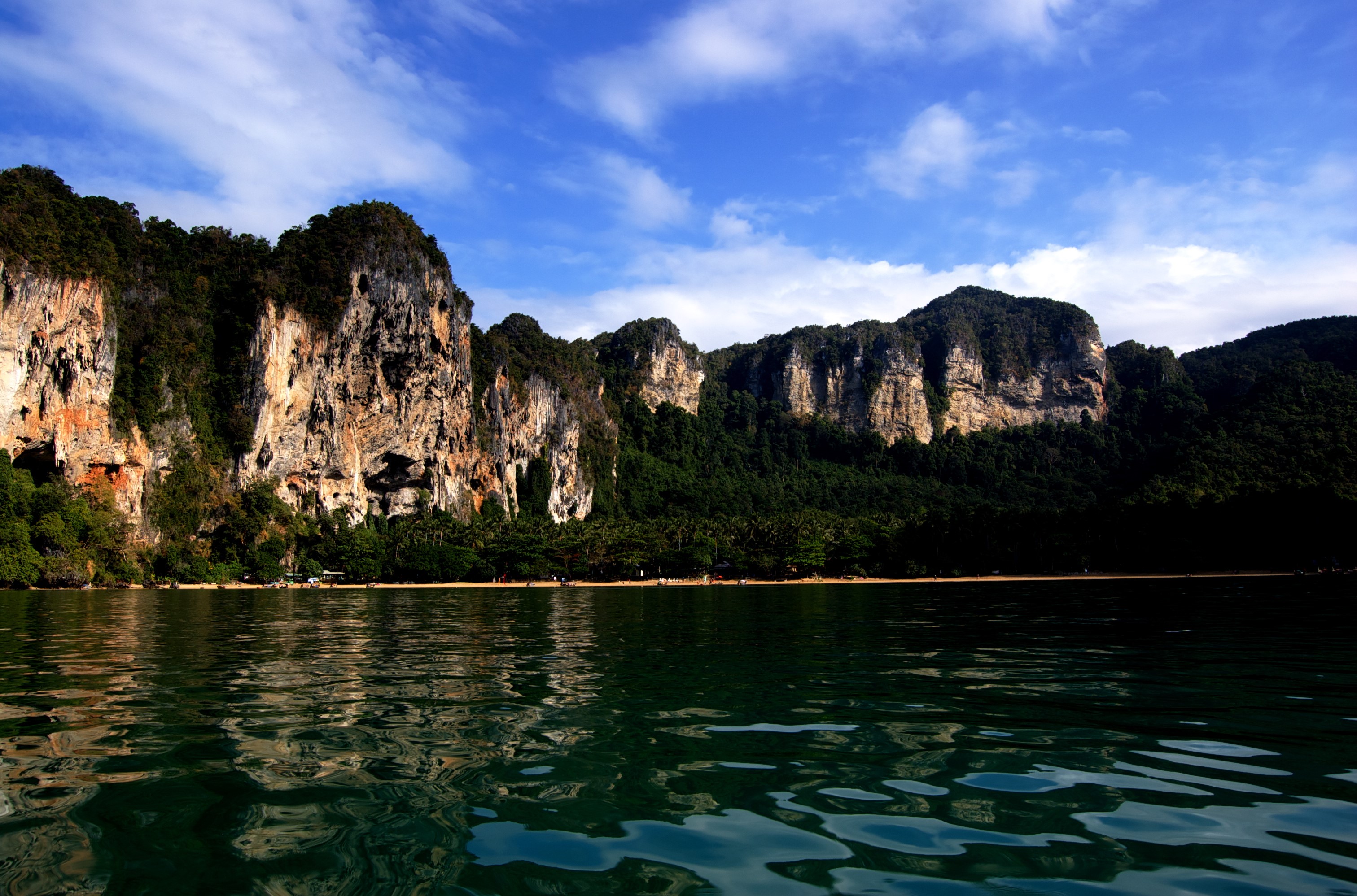 Limestone cliffs and tropical trees by the sea HD Wallpaper