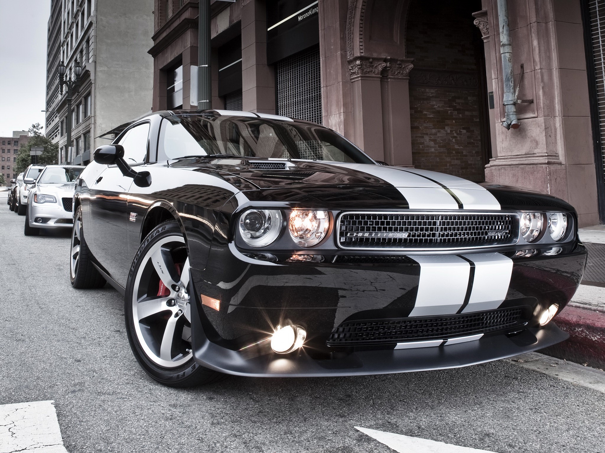 Black Dodge Challenger with white stripes parked on street HD Wallpaper