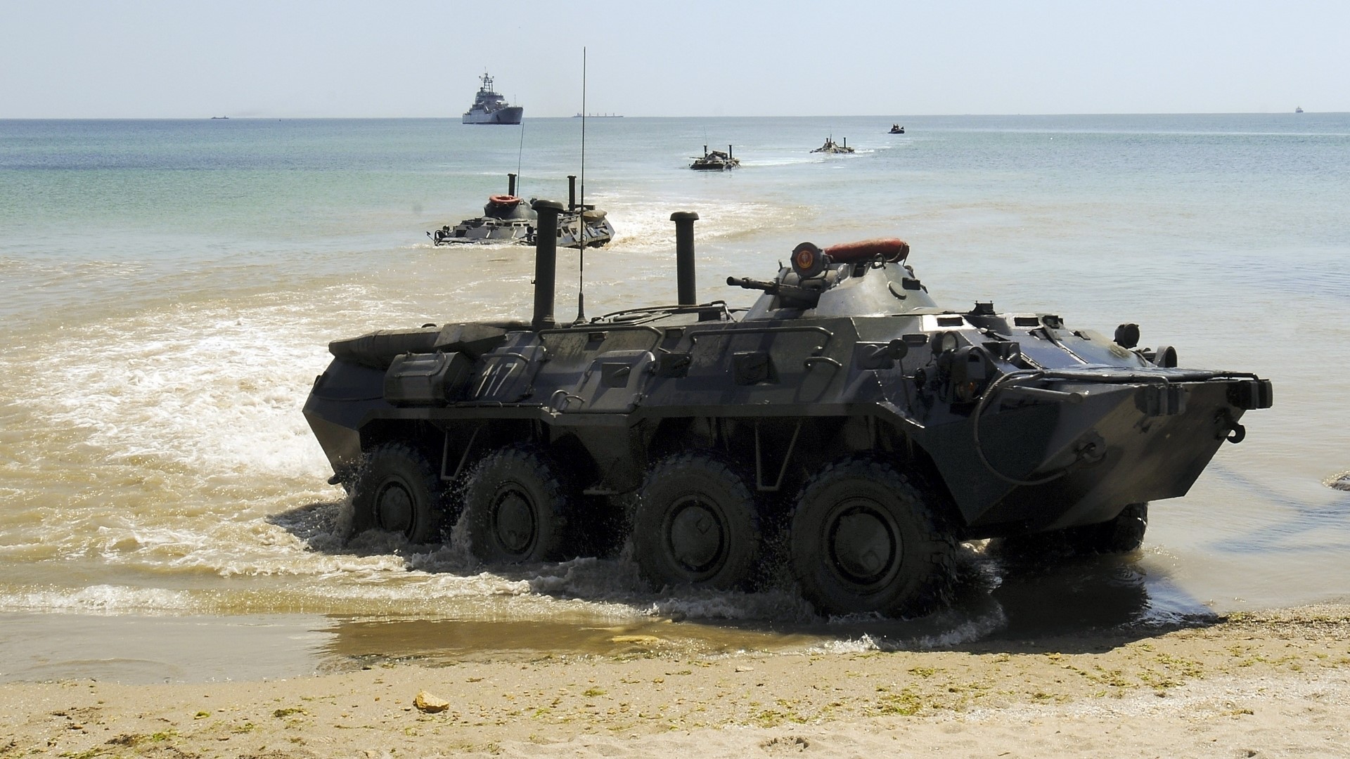 Amphibious military vehicles landing on a beach HD Wallpaper