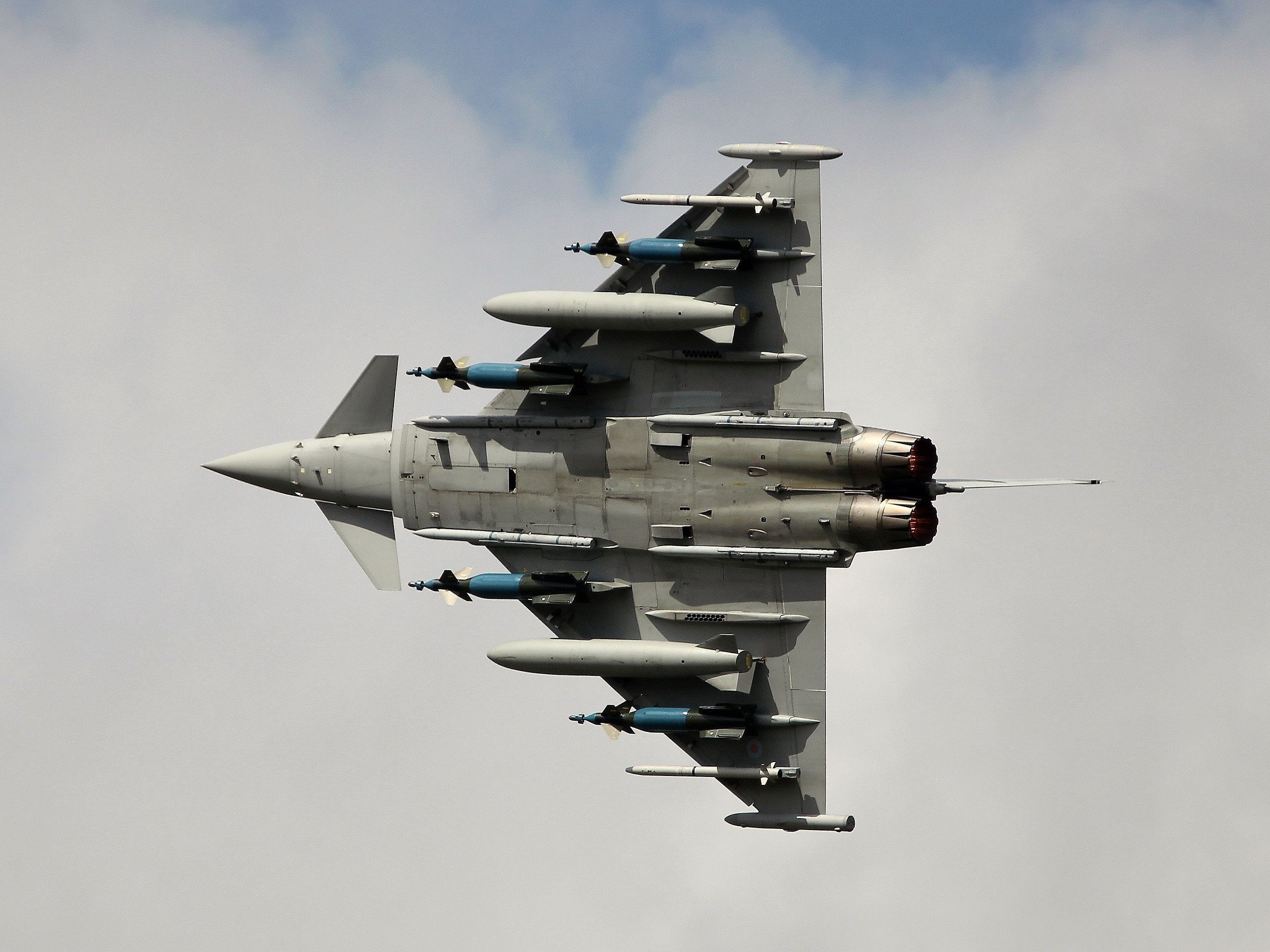 Fighter jet with bombs flying in the sky HD Wallpaper