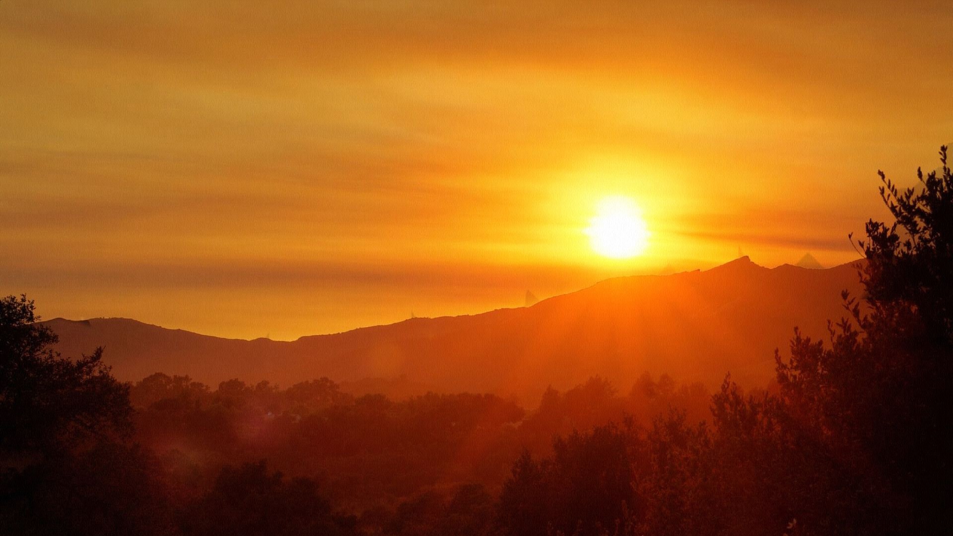 Sunset over mountains and trees HD Wallpaper