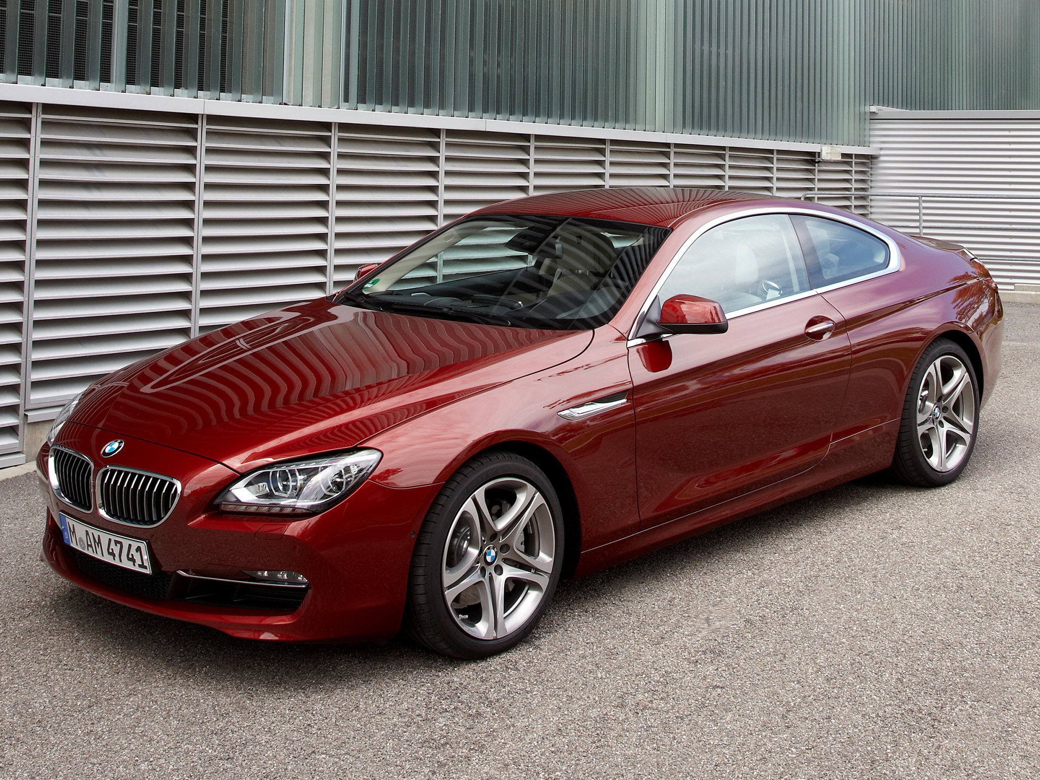 Red BMW 6 Series Coupe parked outside a modern building HD Wallpaper