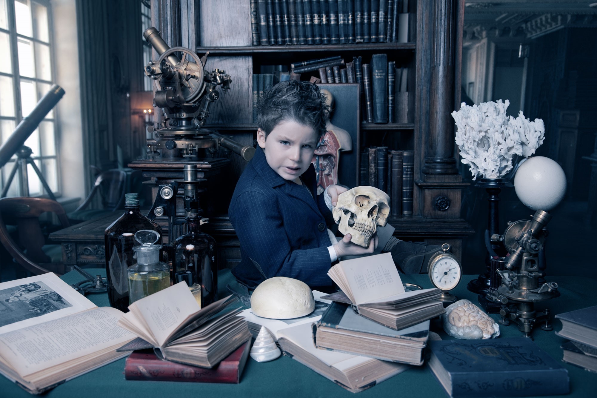 Boy in a study holding a skull HD Wallpaper