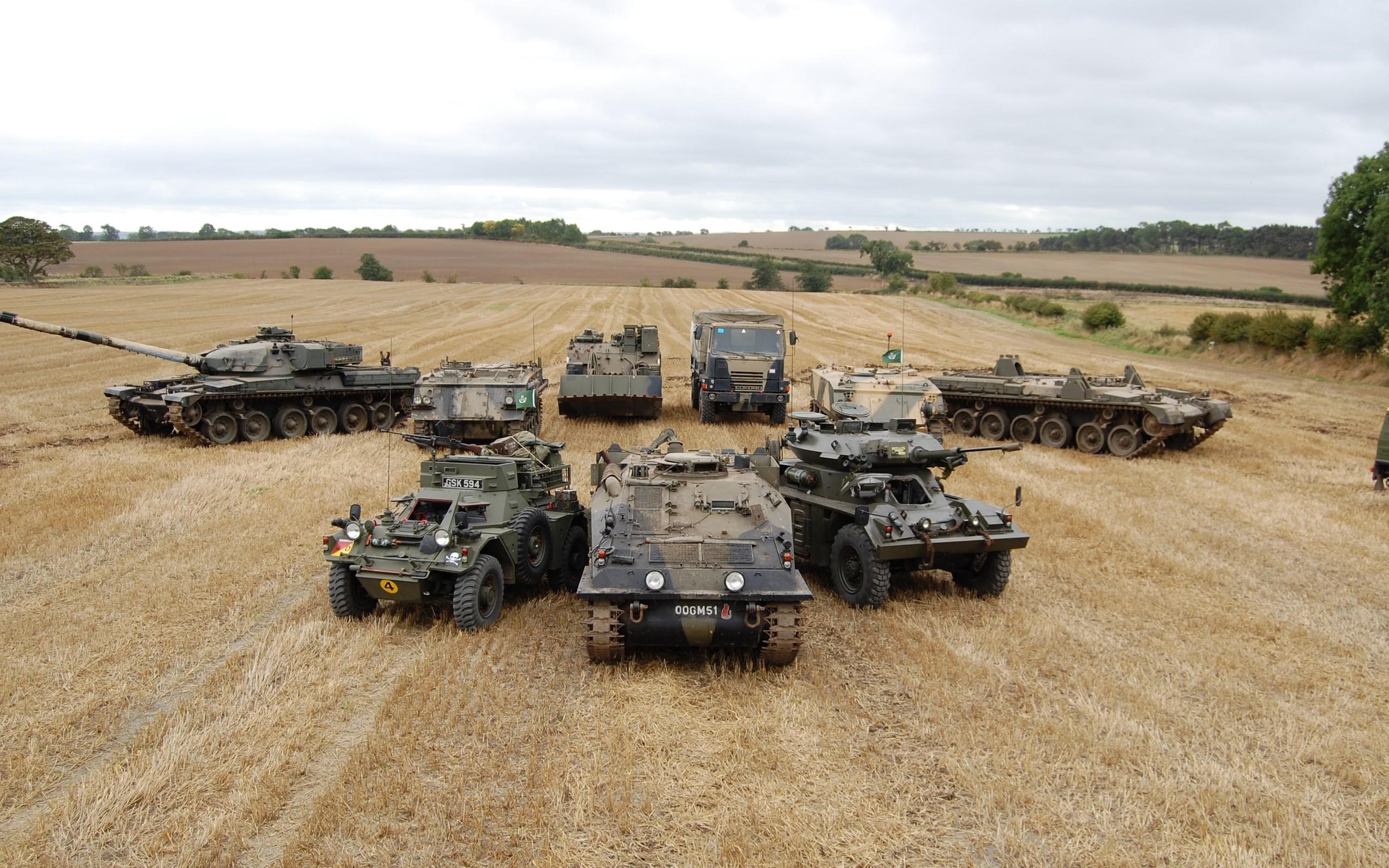 Military vehicles parked in a field HD Wallpaper