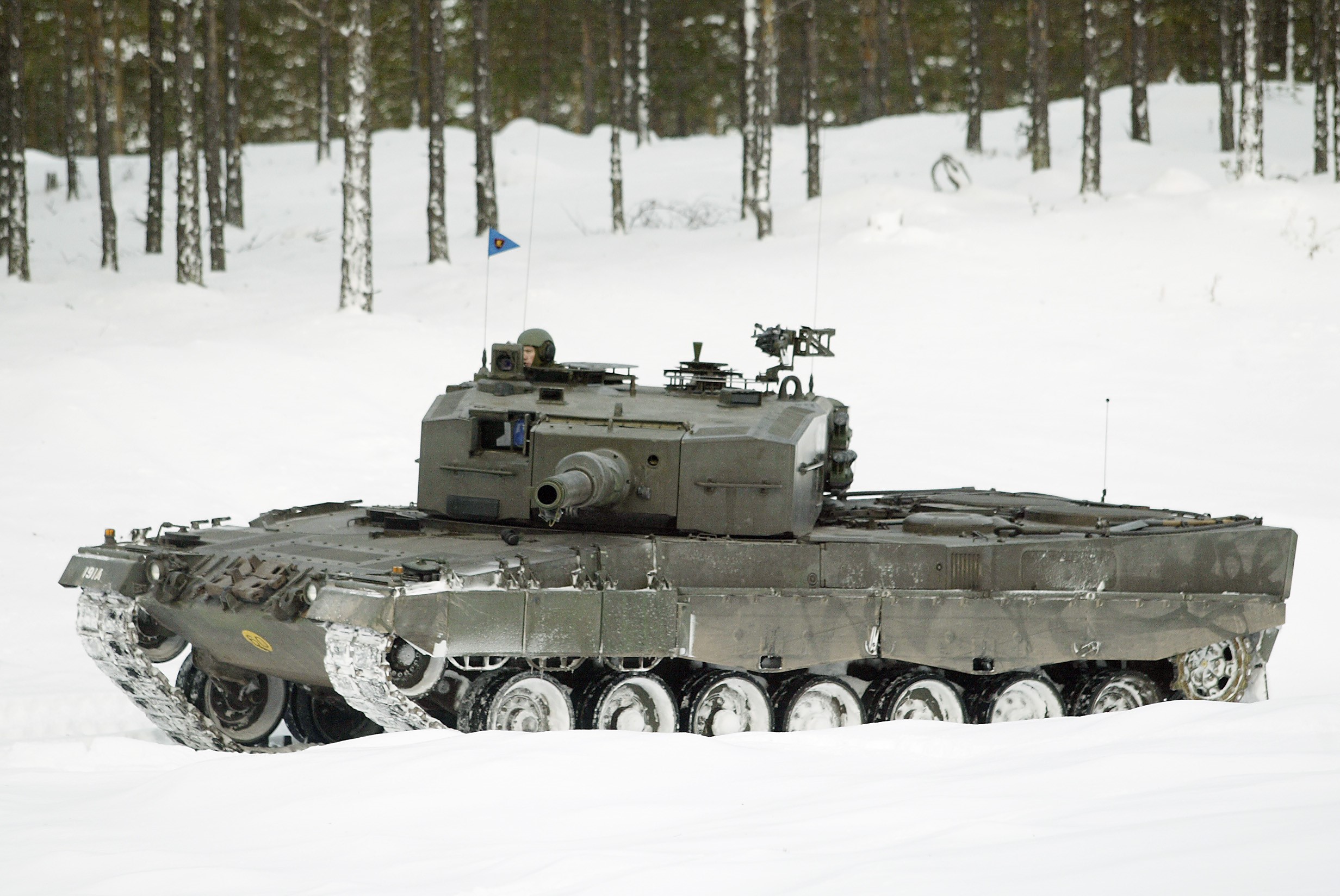Leopard 2 tank in a snowy forest HD Wallpaper