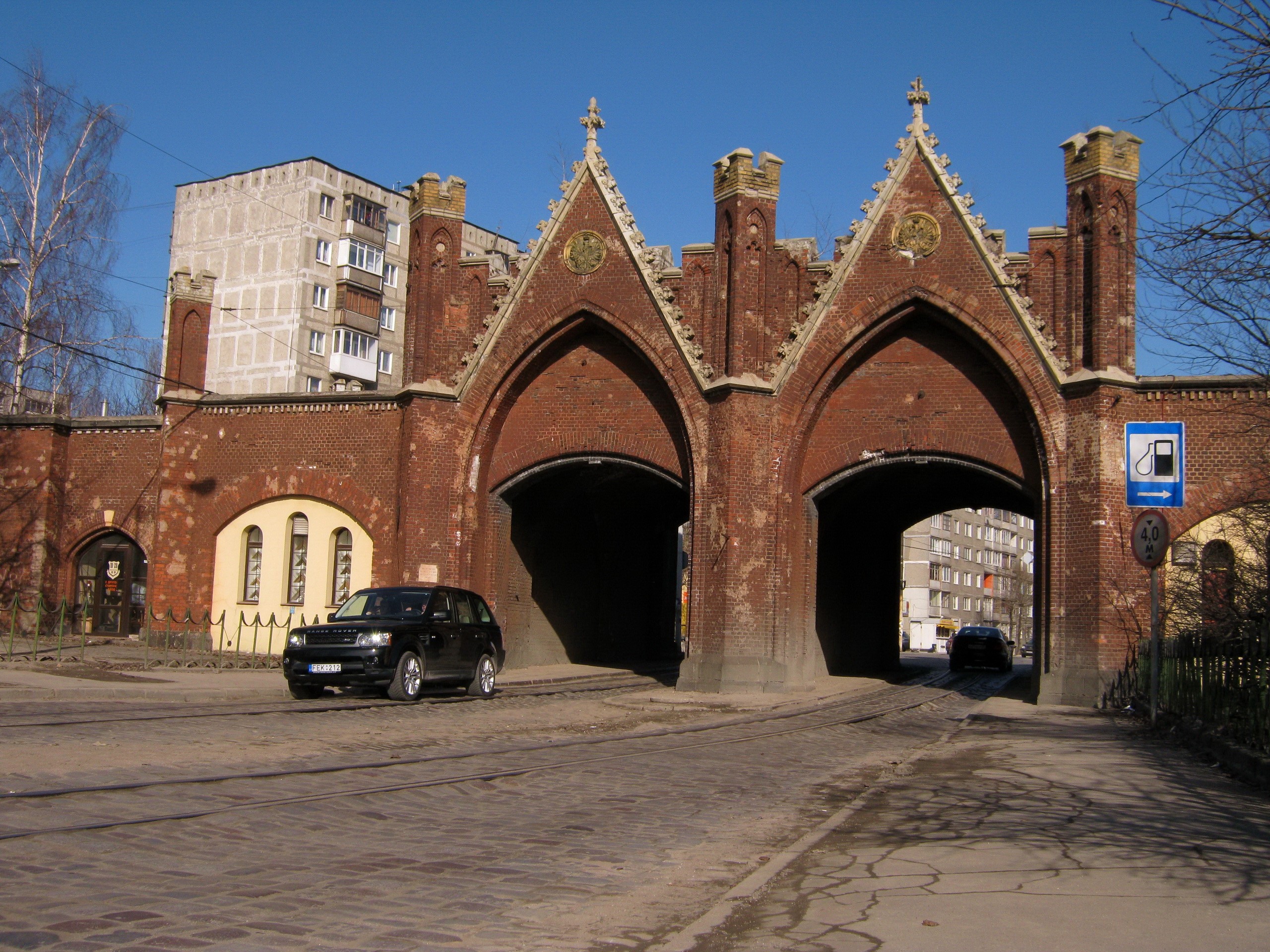 Fortress gates with cars and tram tracks HD Wallpaper