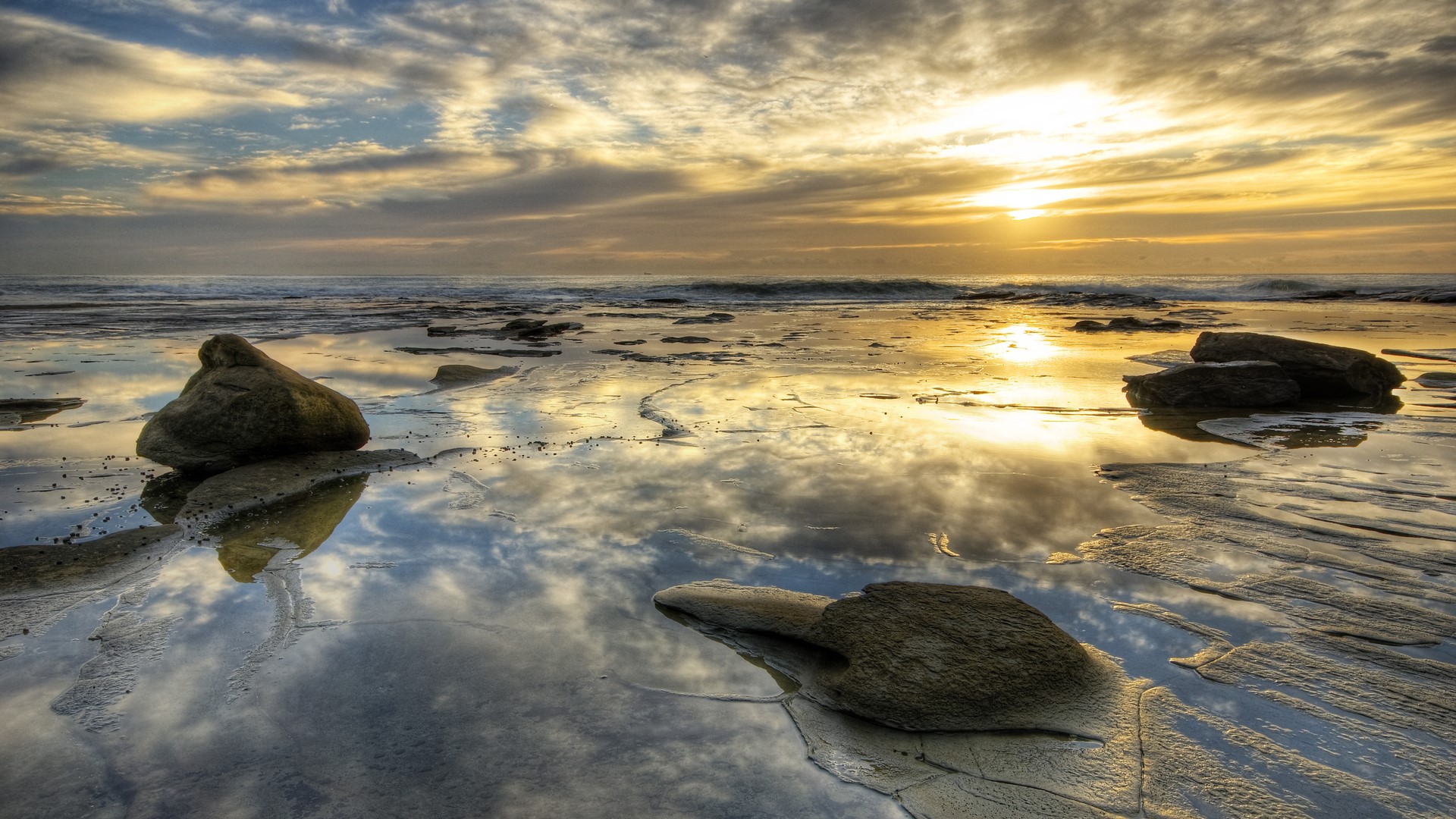 Sunset over the ocean with reflections on the beach HD Wallpaper