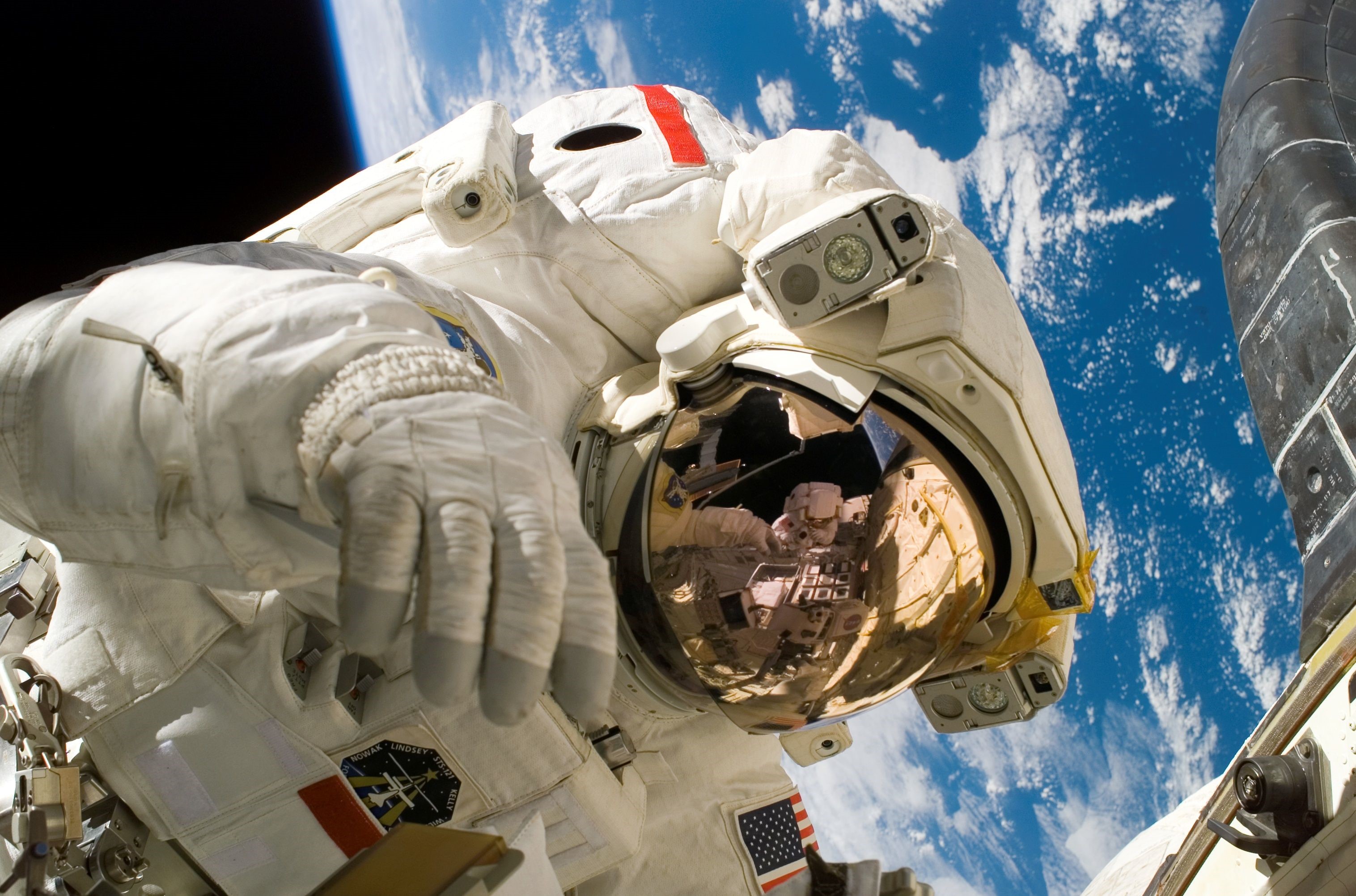 Astronaut in a spacesuit on the International Space Station HD Wallpaper