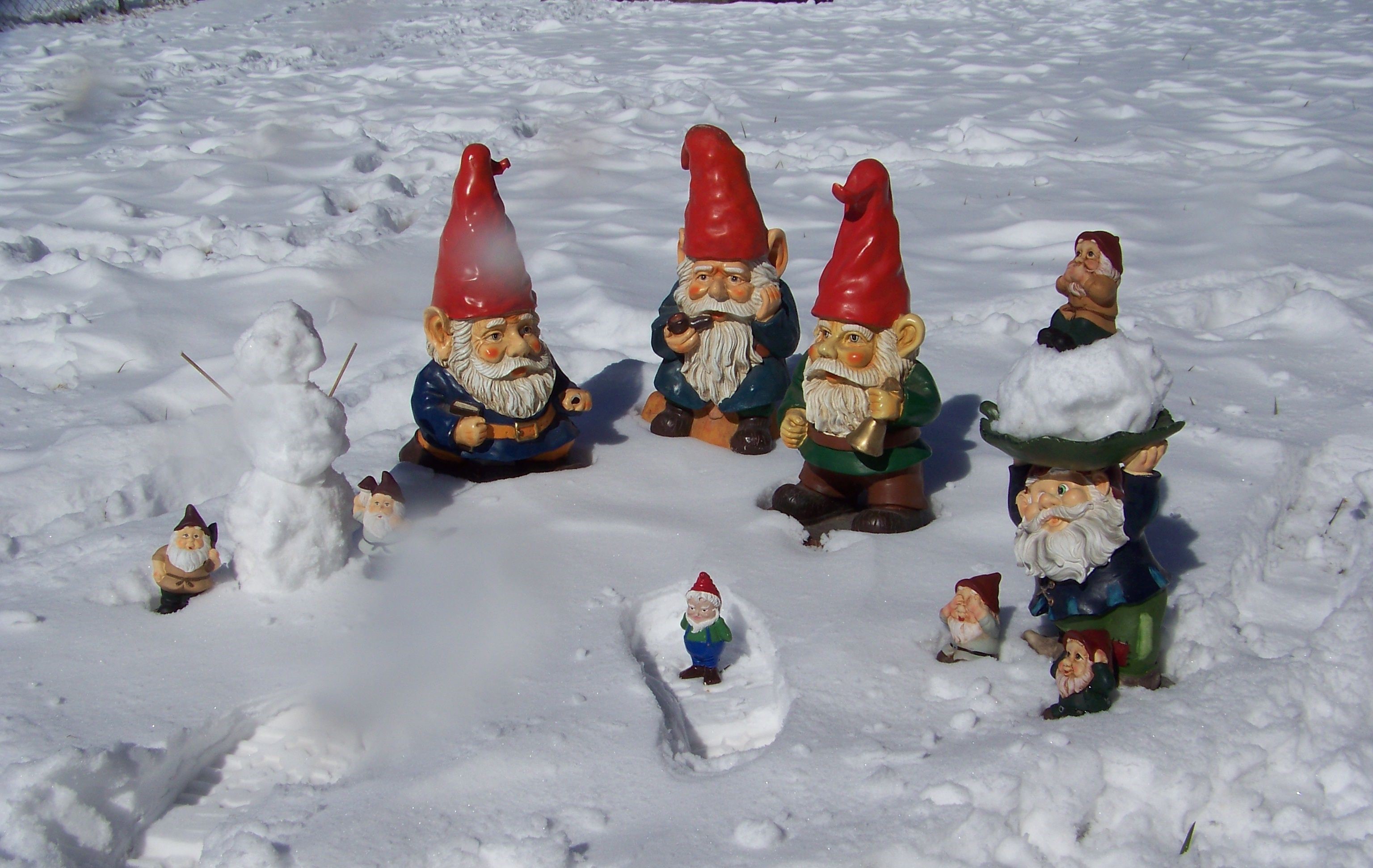 Garden gnomes and snowman in the snow HD Wallpaper