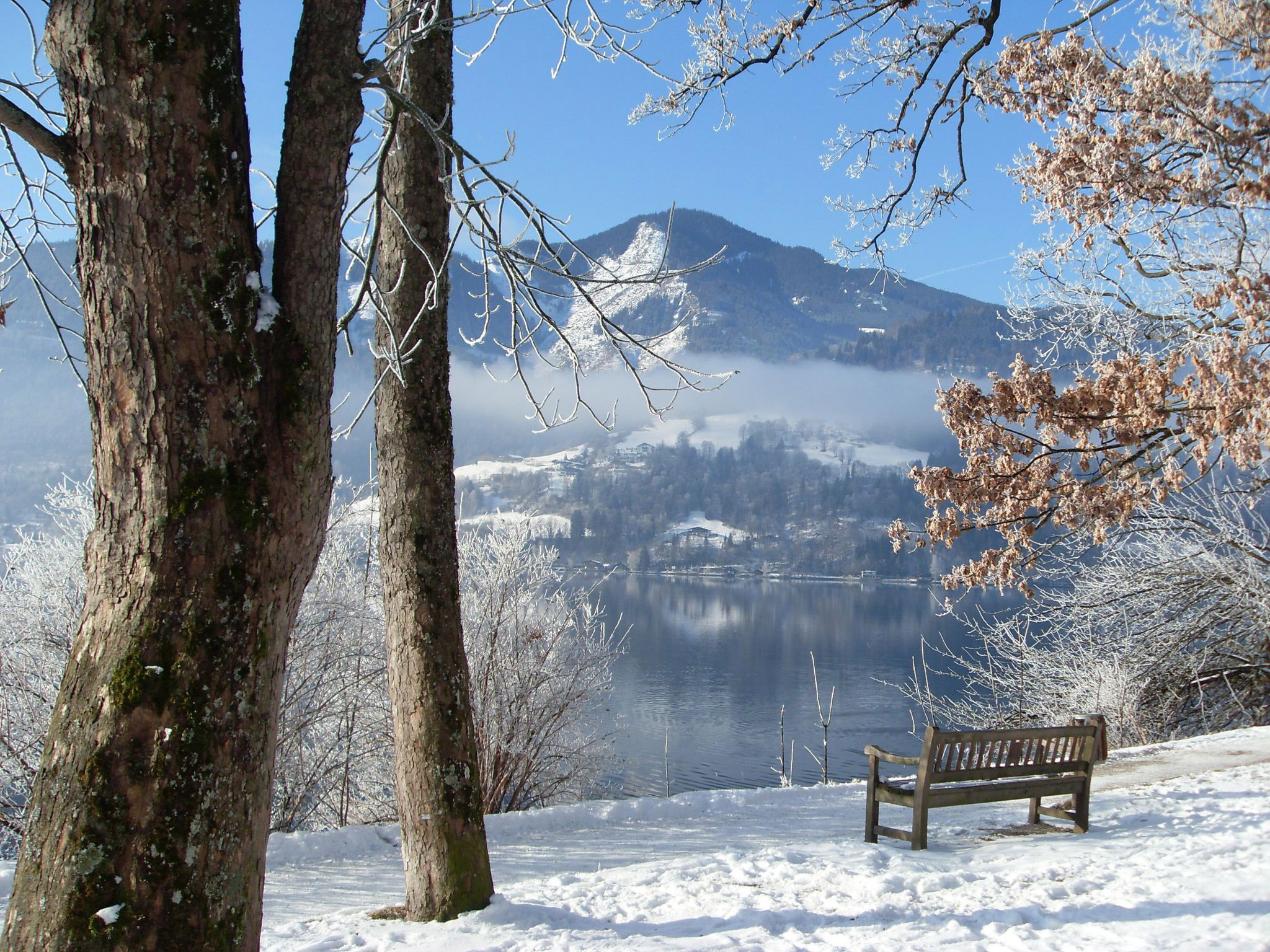 Winter scene with snow-covered mountains and a lake HD Wallpaper