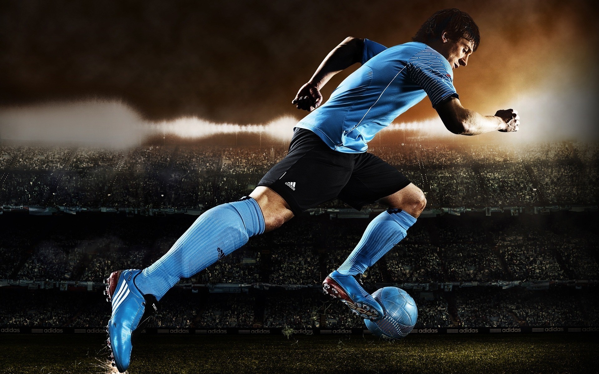 Soccer player in Adidas uniform running with ball HD Wallpaper
