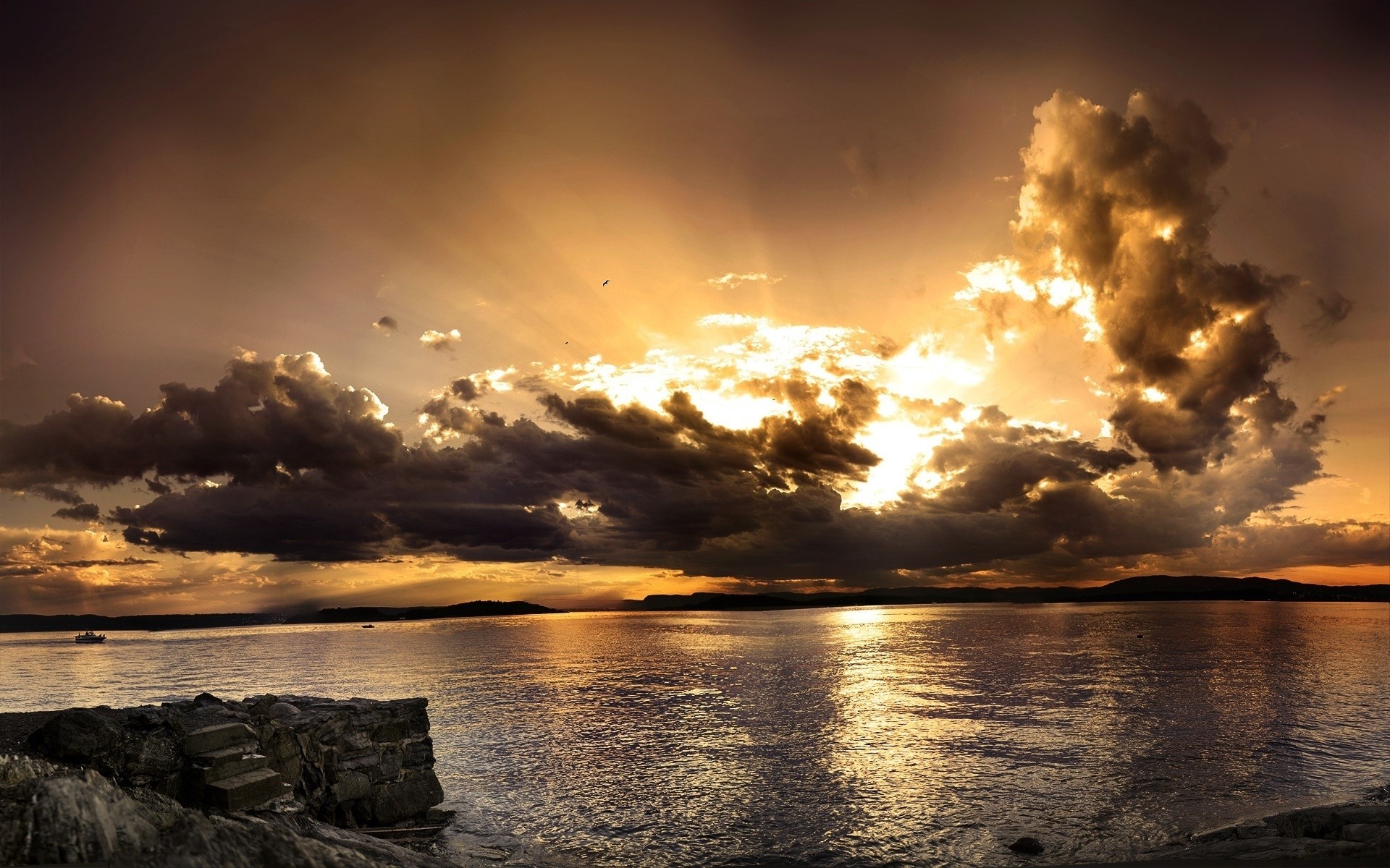 Sunset over the water with dramatic clouds HD Wallpaper