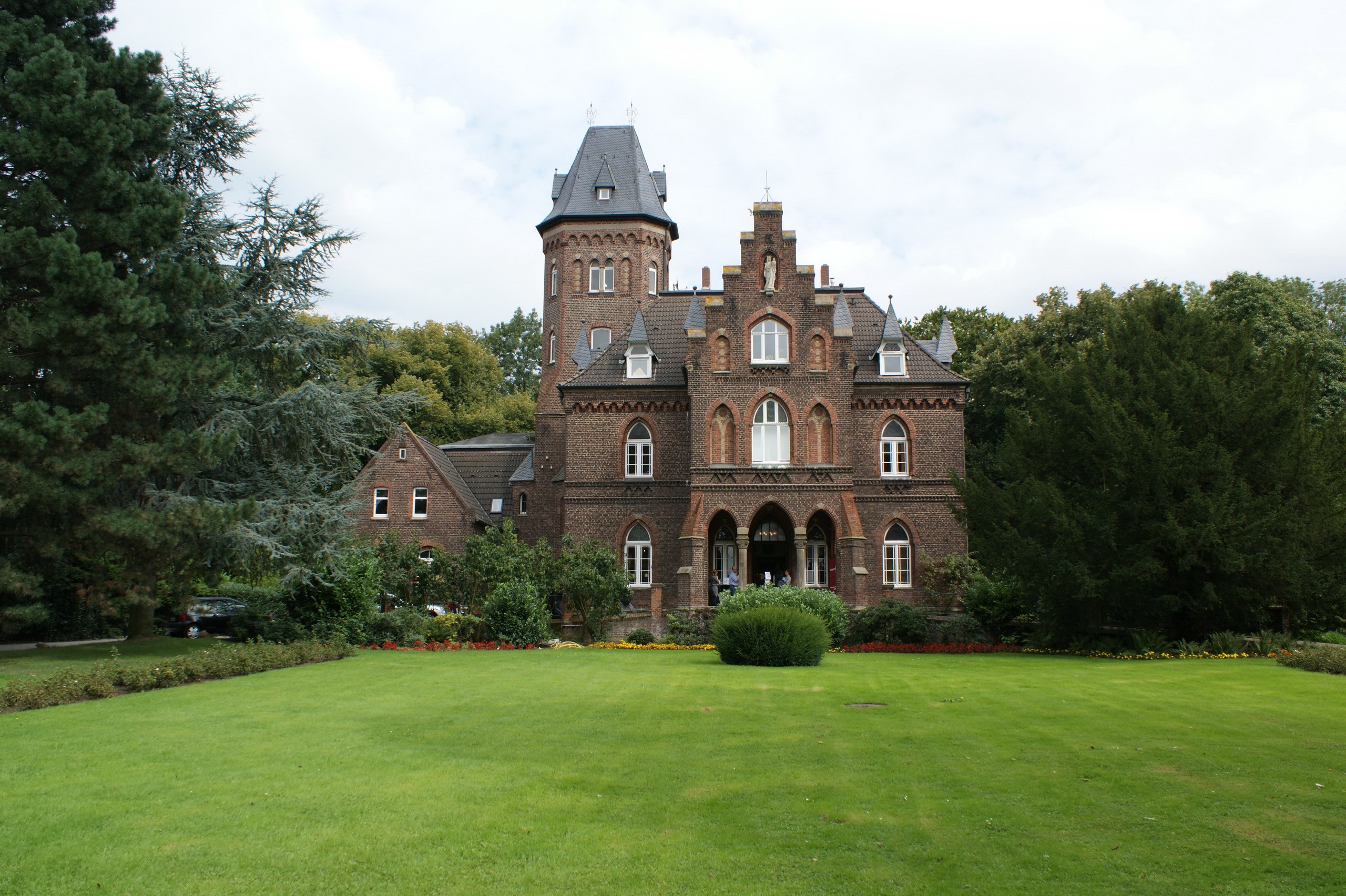 Brick castle with tower and green lawn HD Wallpaper