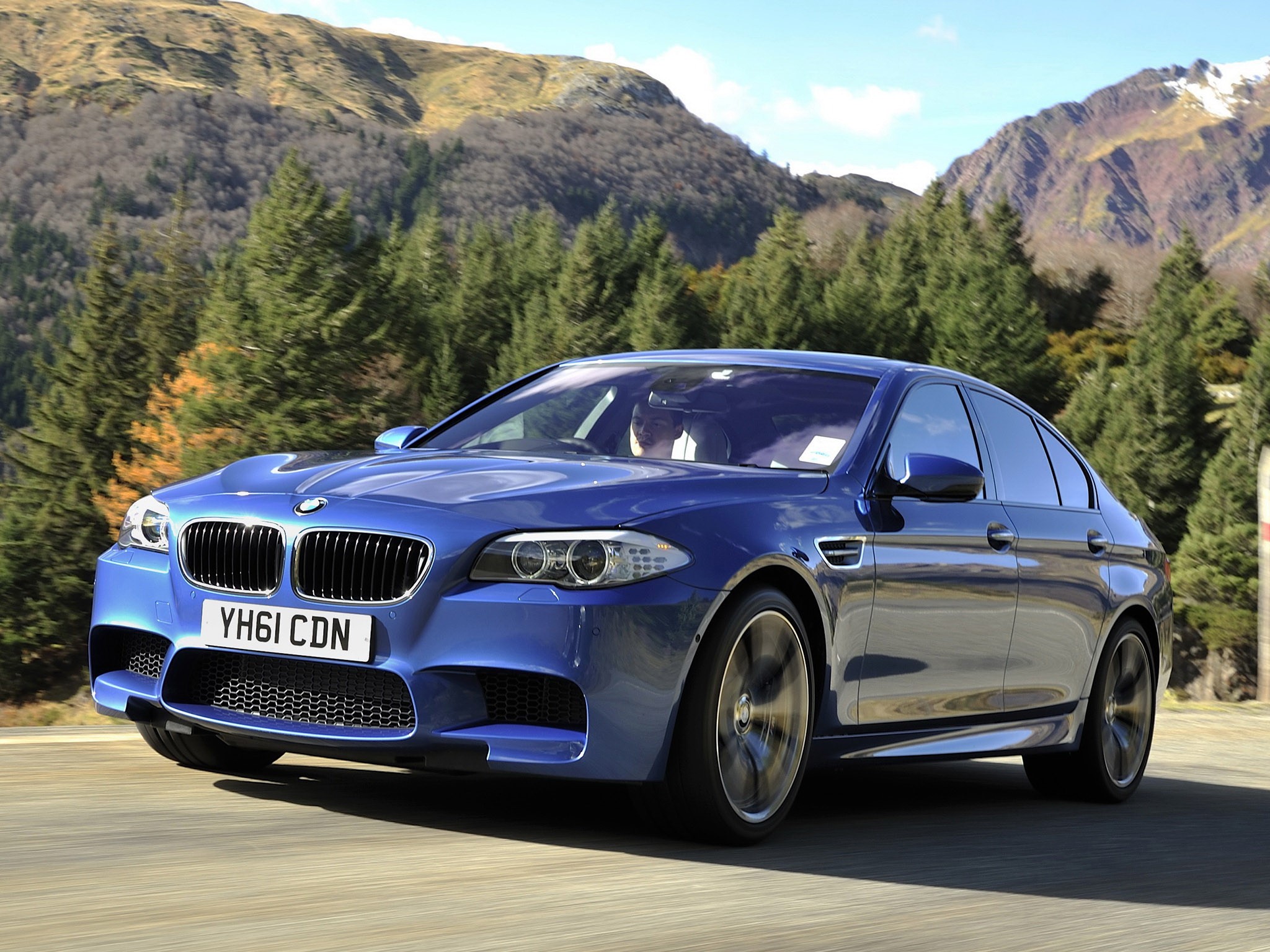 Blue BMW M5 Driving on Mountain Road HD Wallpaper