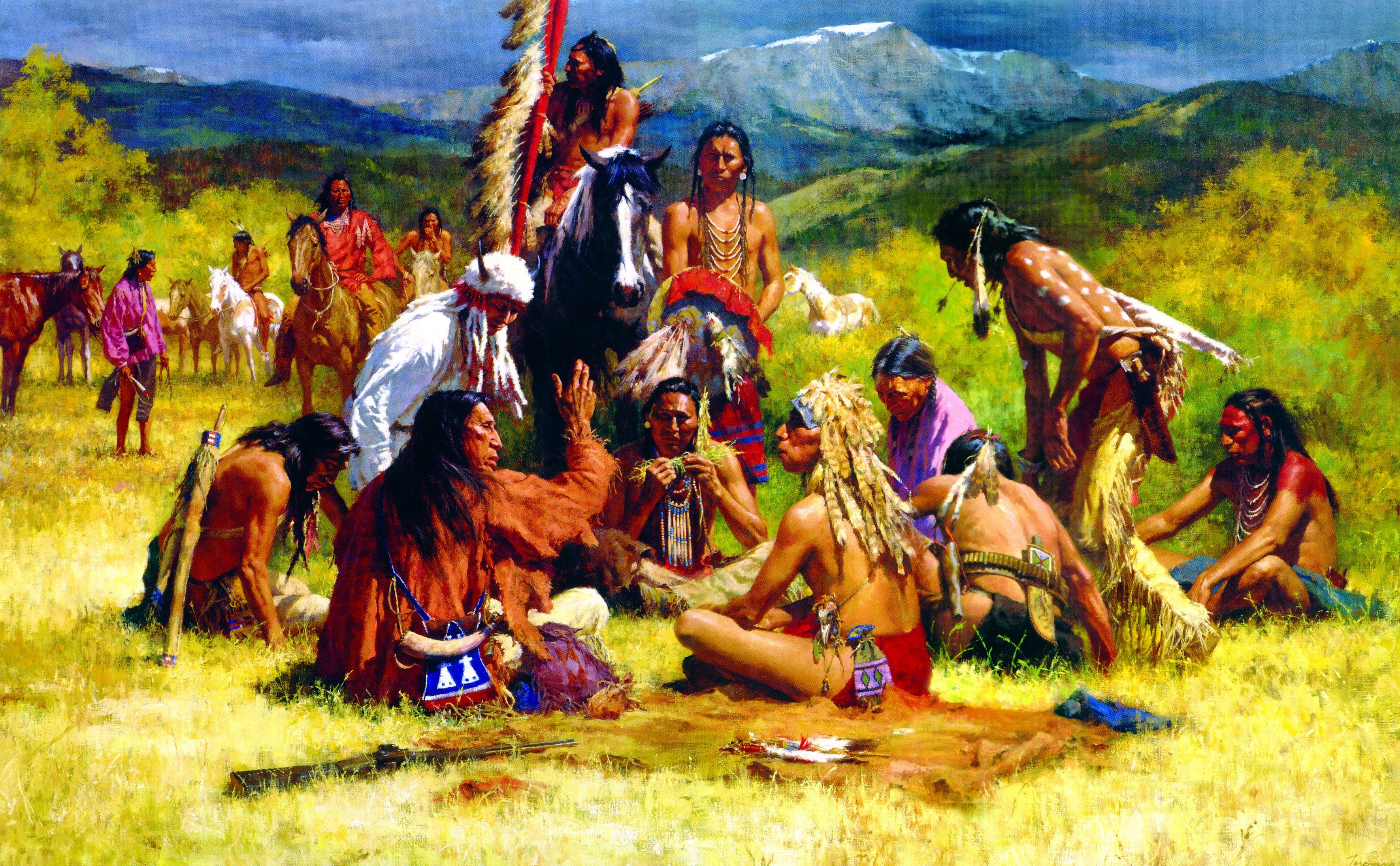 Native American men gathered in a field with mountains in the background HD Wallpaper