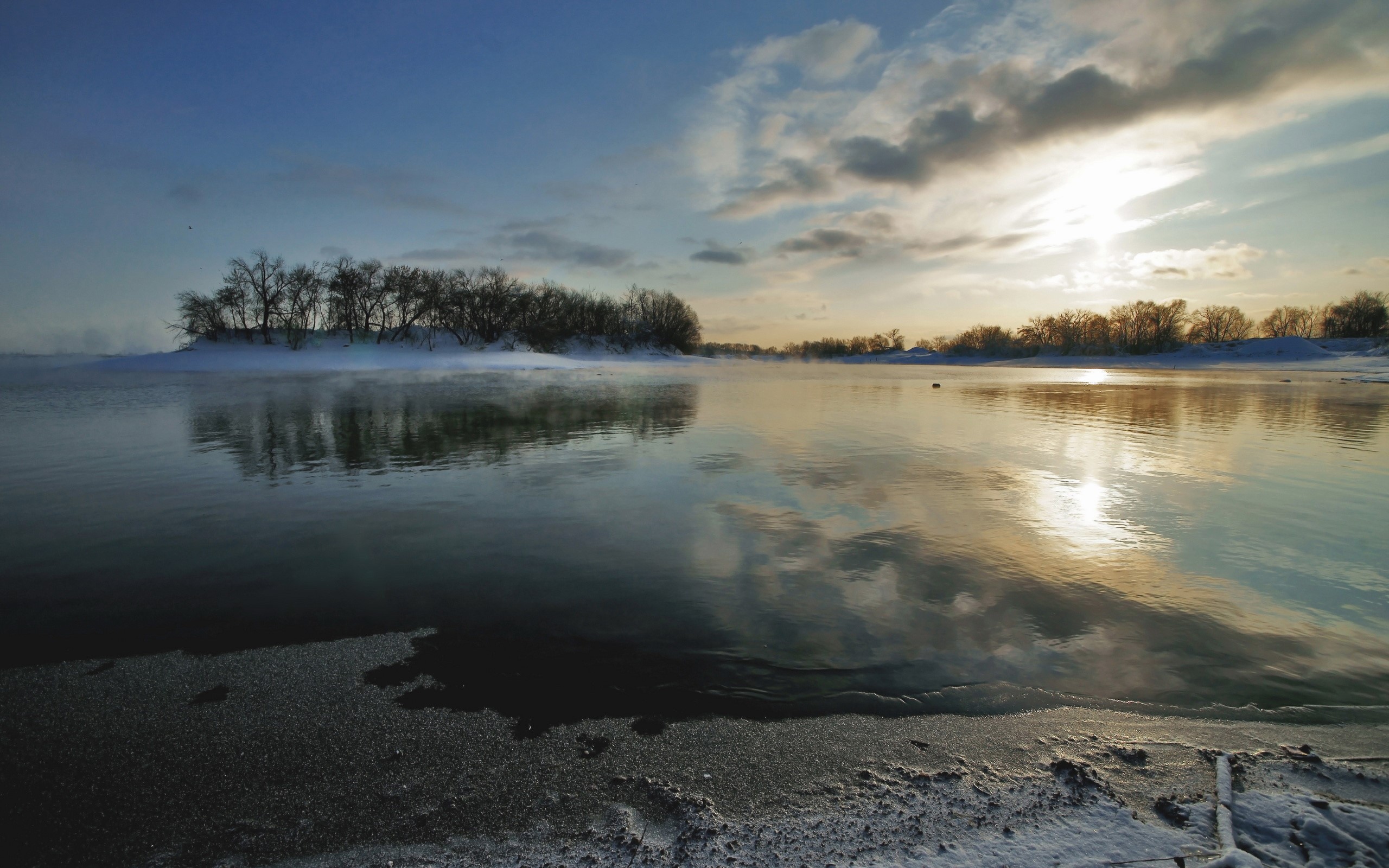 Sunrise over a frozen river with trees and mist HD Wallpaper