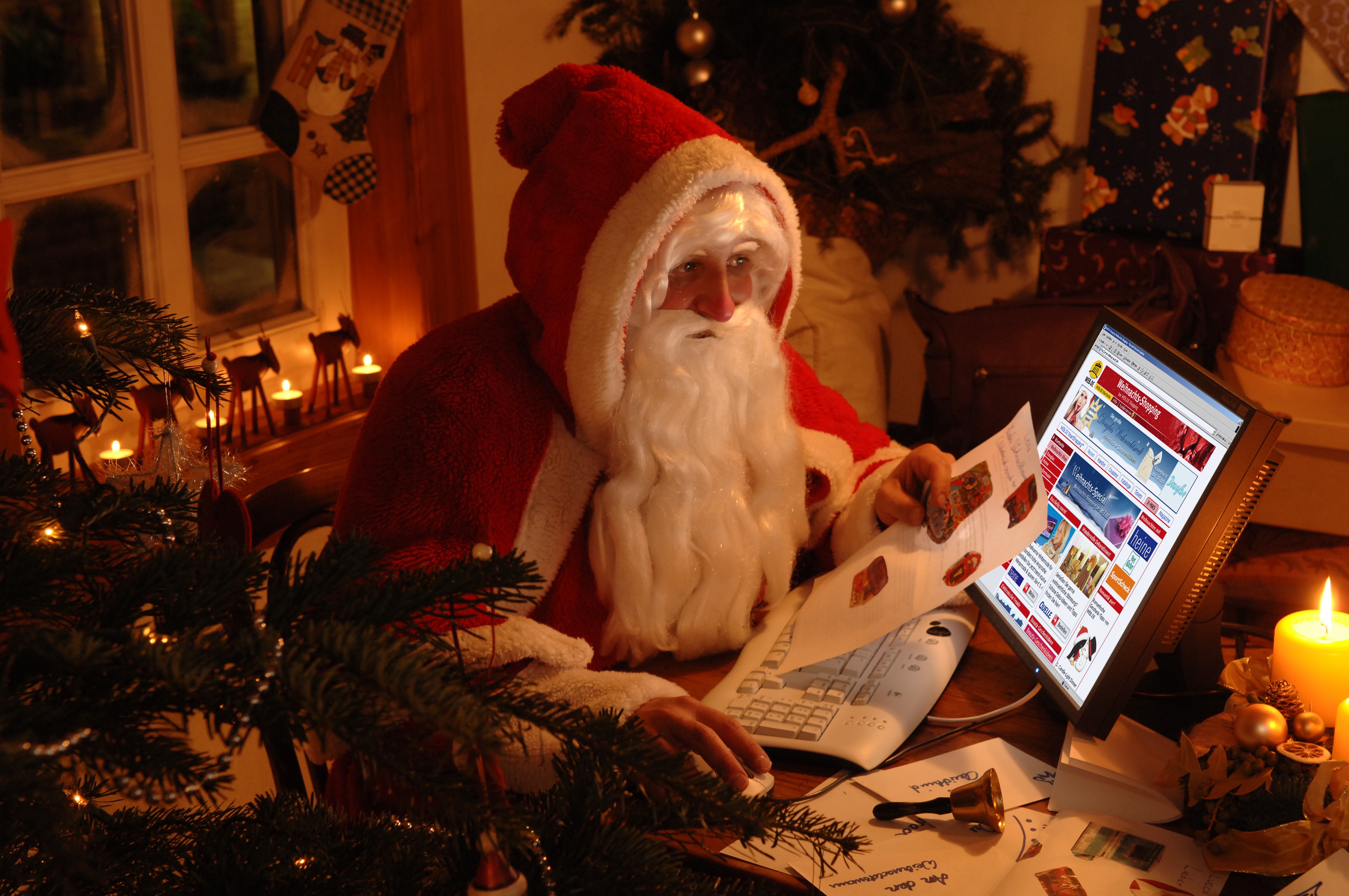 Santa Claus using a computer on Christmas HD Wallpaper