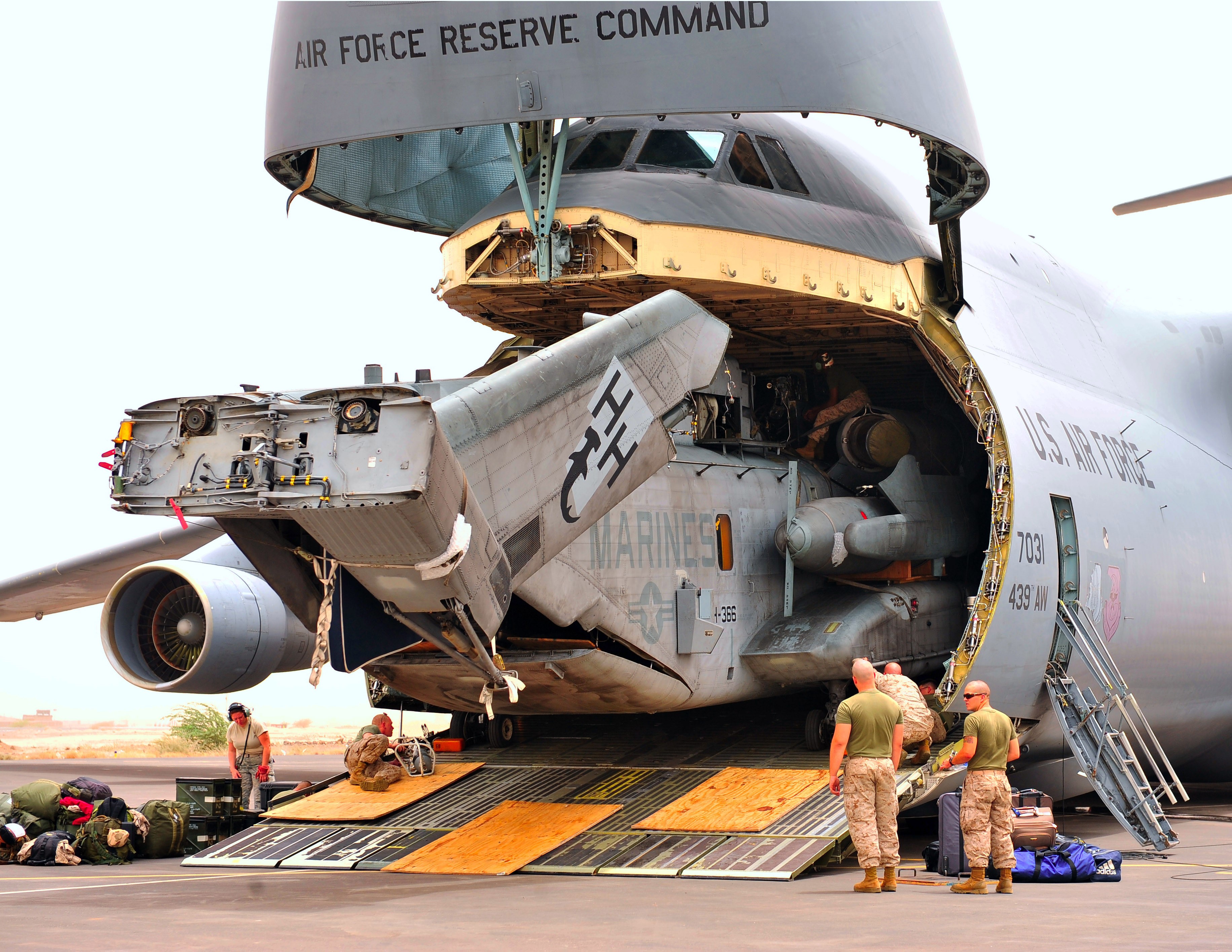 US Air Force C-5 Galaxy loading helicopter HD Wallpaper
