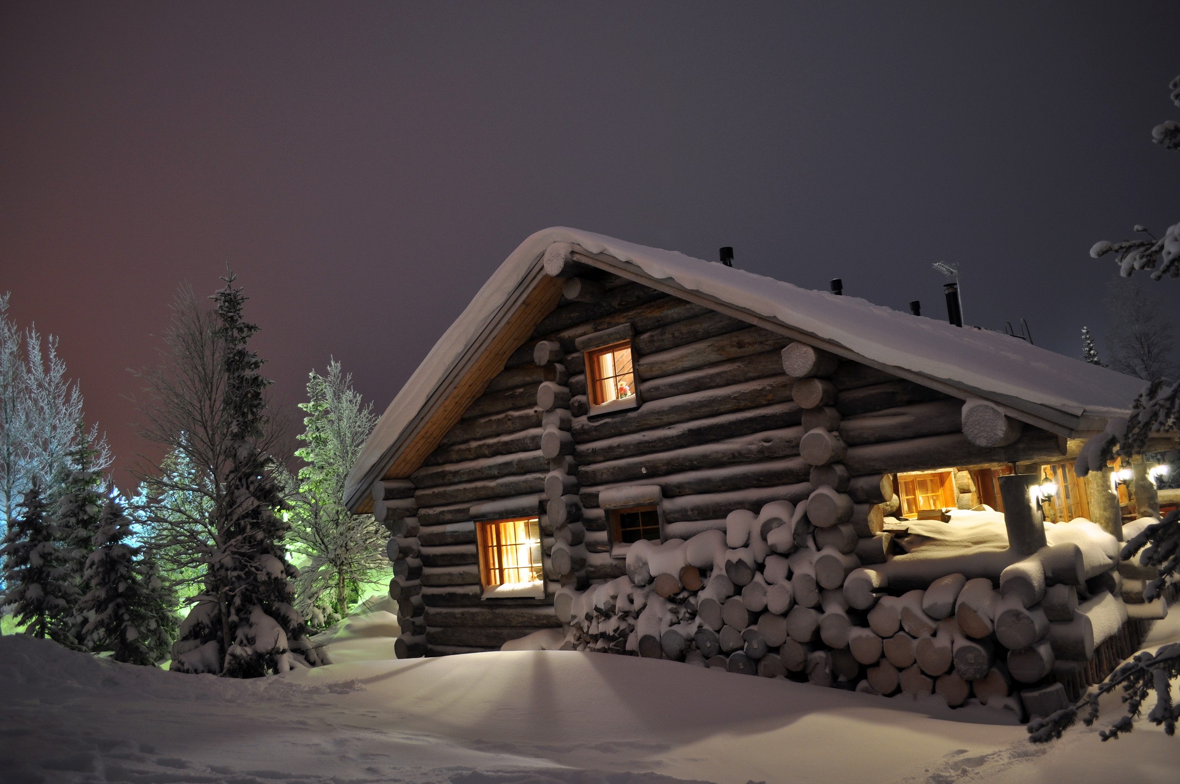 Log cabin in the snow at night HD Wallpaper