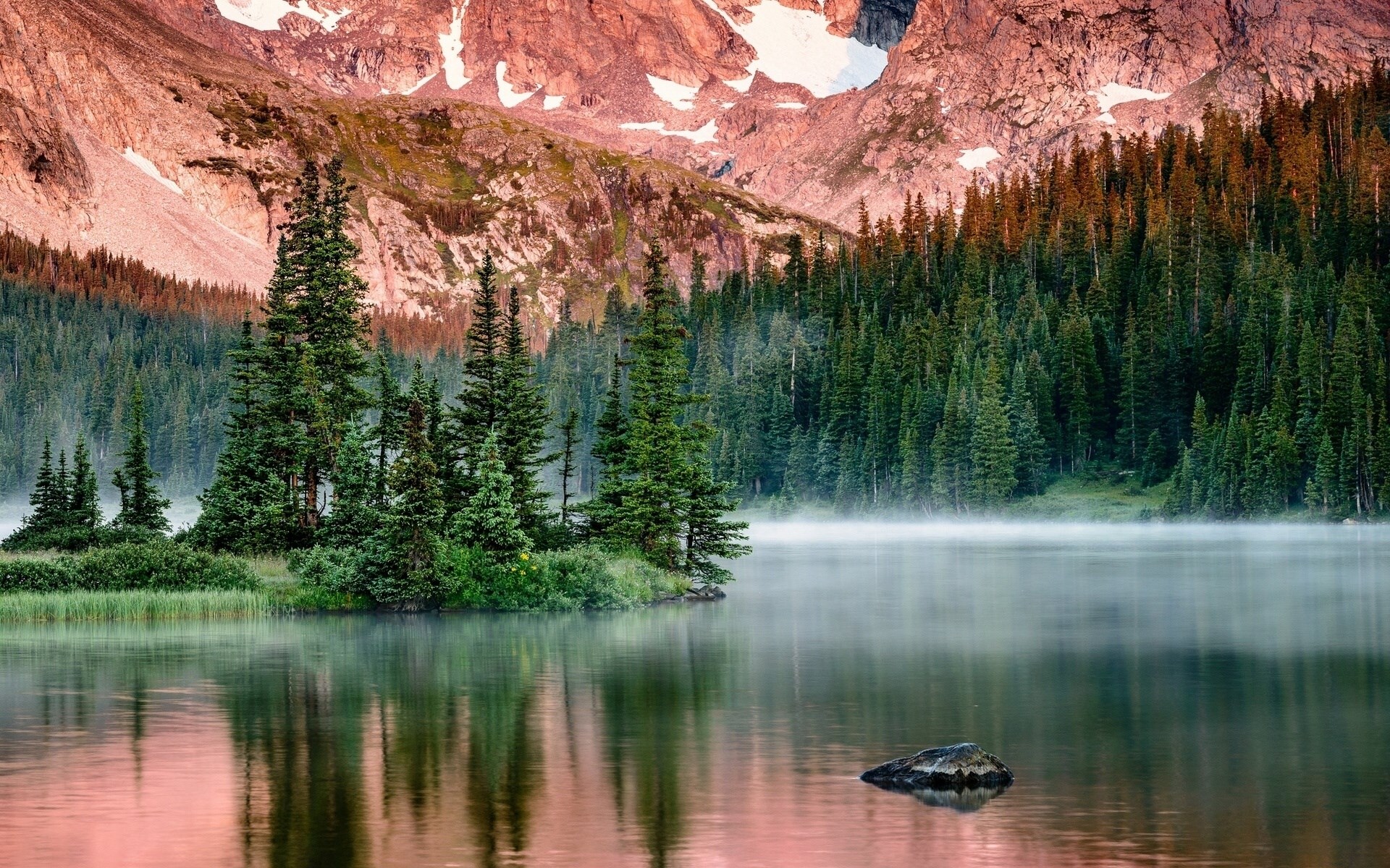 Misty mountain lake with pine forest and rocky peaks HD Wallpaper