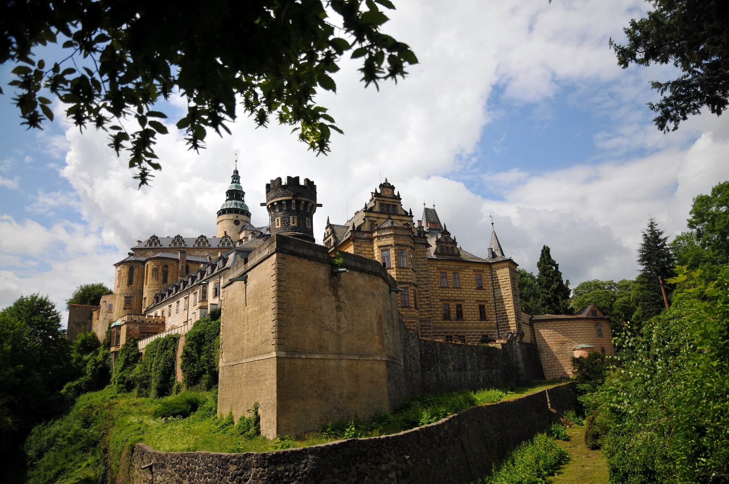 Castle on a hill with trees and clouds HD Wallpaper