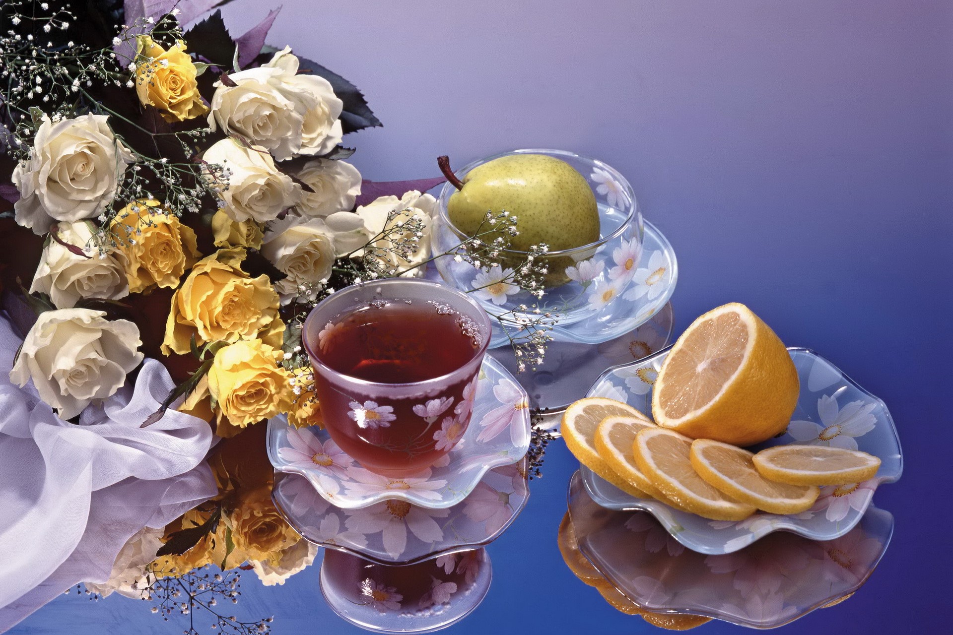 Roses, tea, pear, and lemon slices on a reflective surface HD Wallpaper