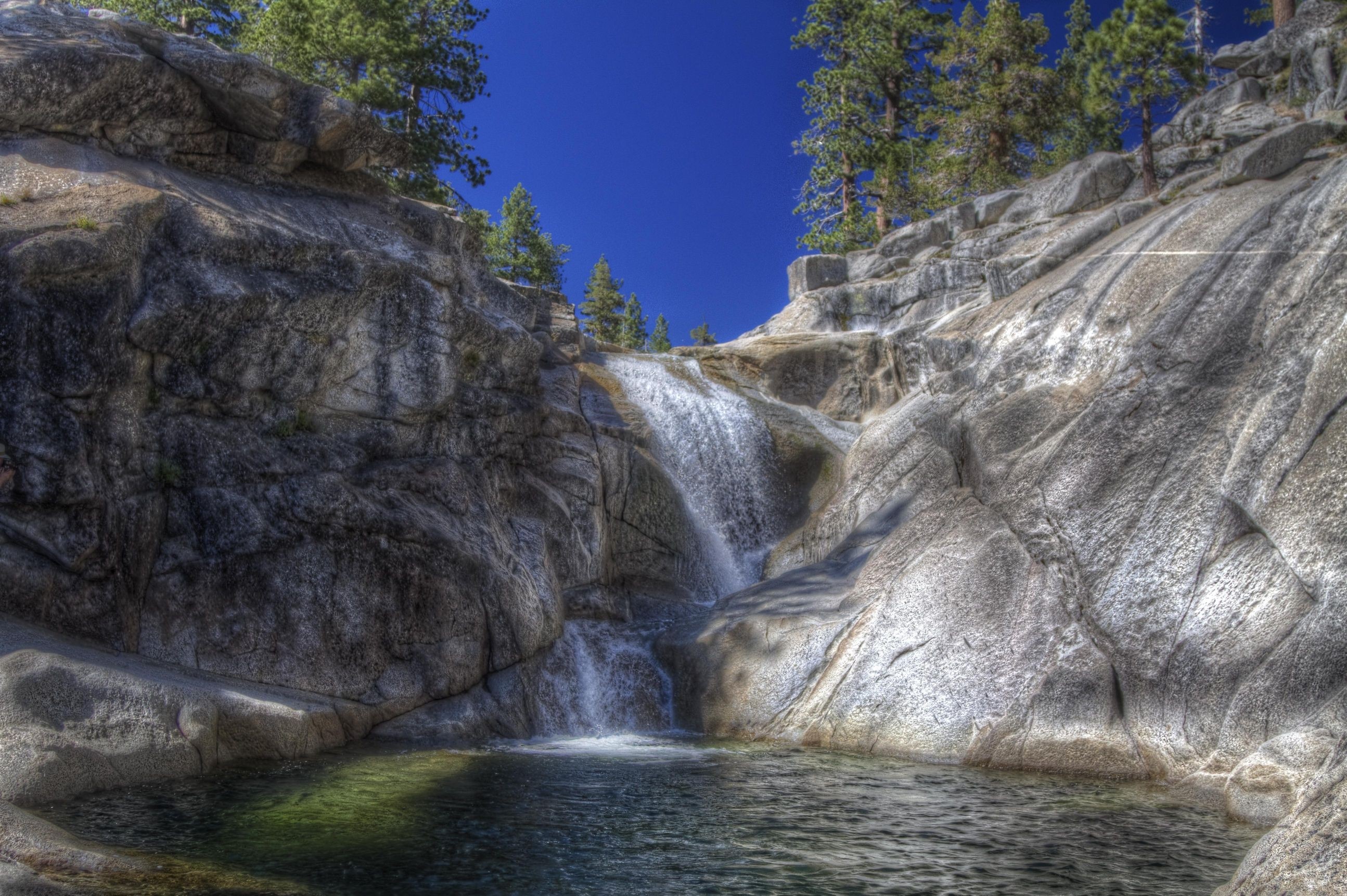 Waterfall cascading over rocks in Yosemite National Park HD Wallpaper