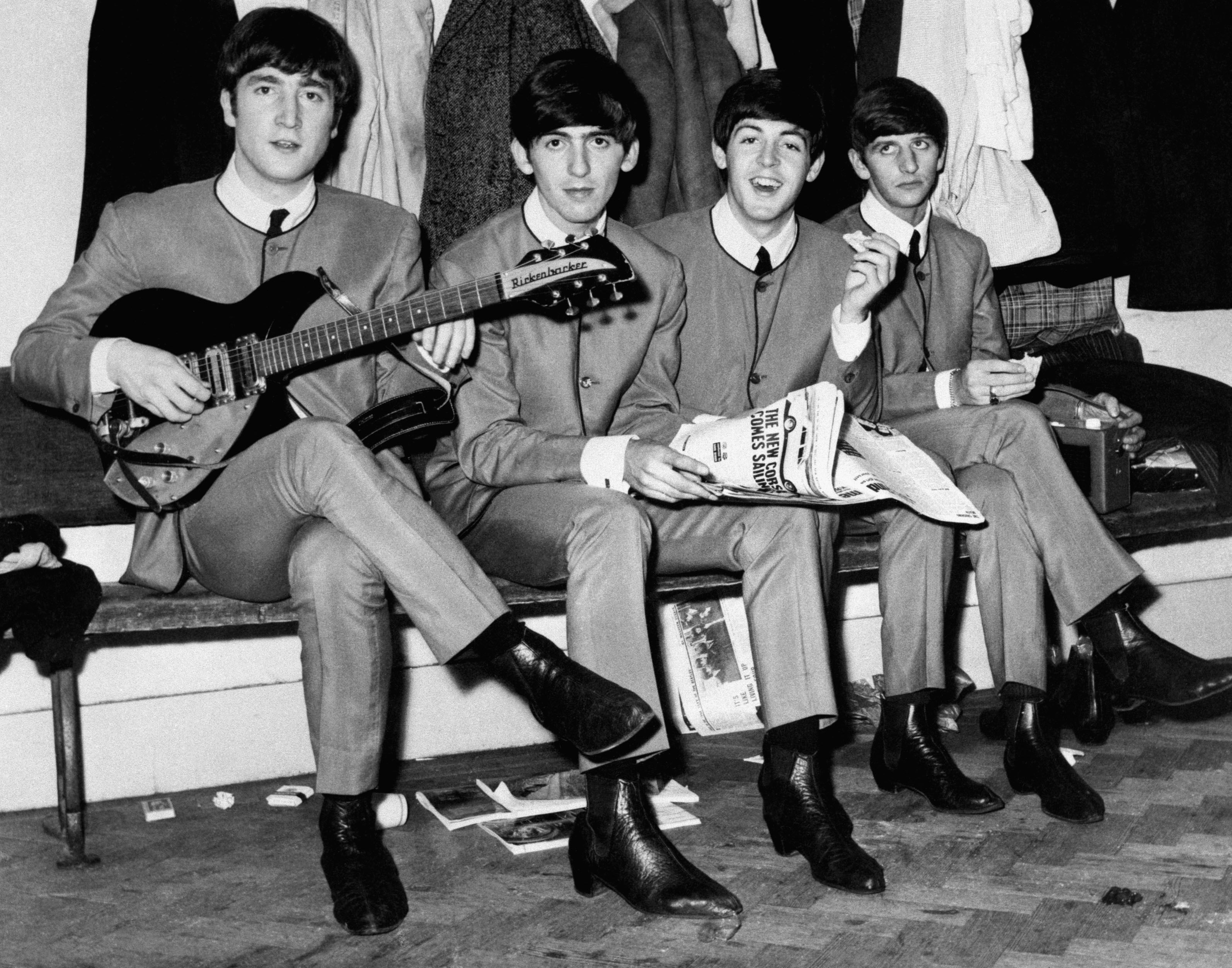 The Beatles sitting on a bench with guitars HD Wallpaper