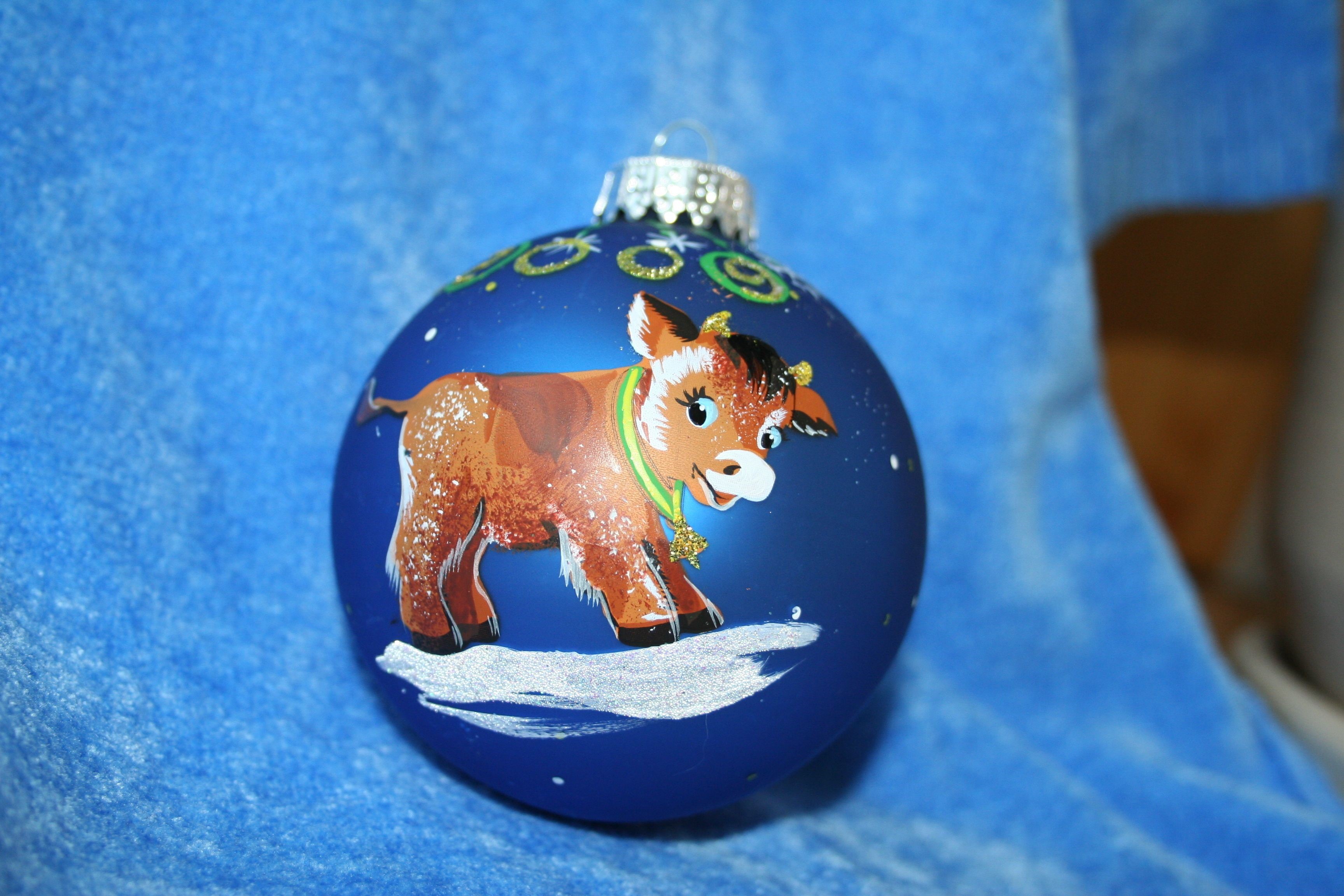 Christmas ornament with a painted cow HD Wallpaper