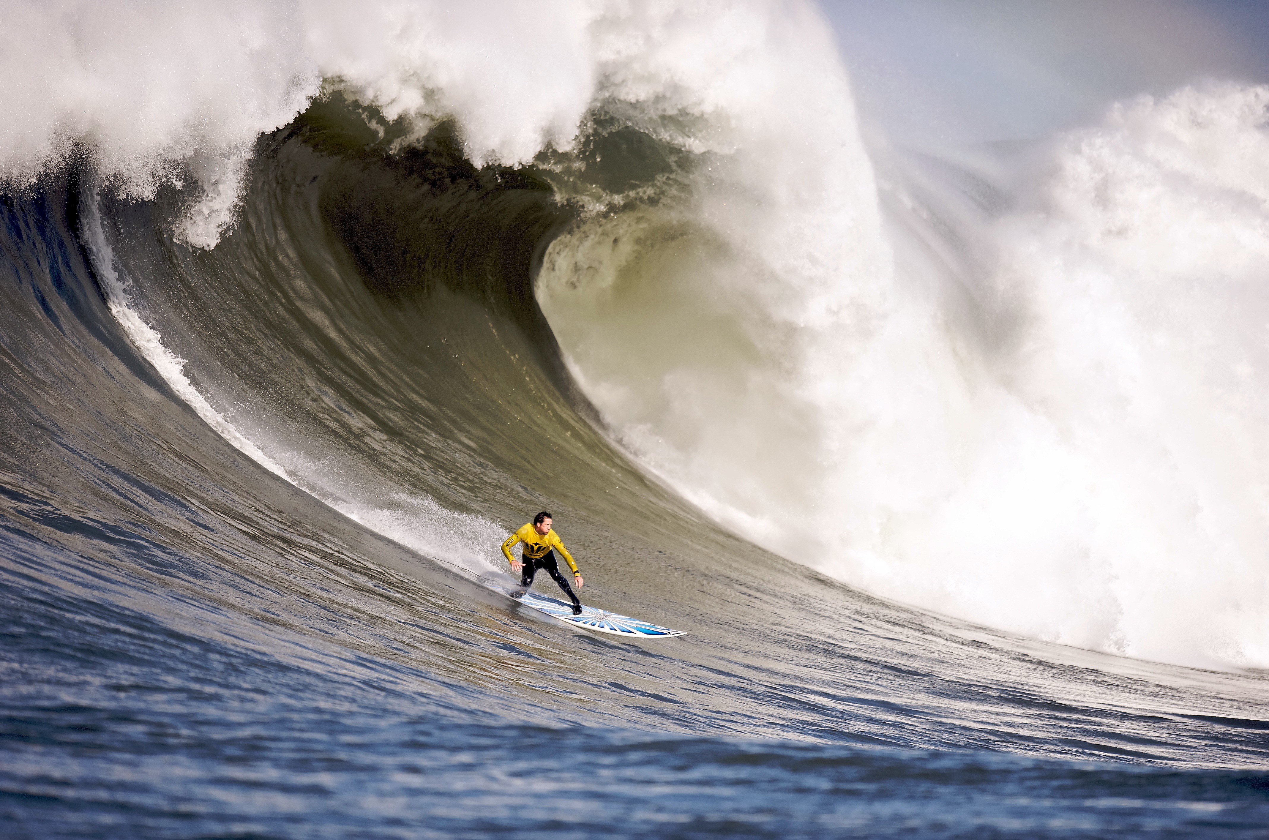 Surfer riding a massive wave HD Wallpaper