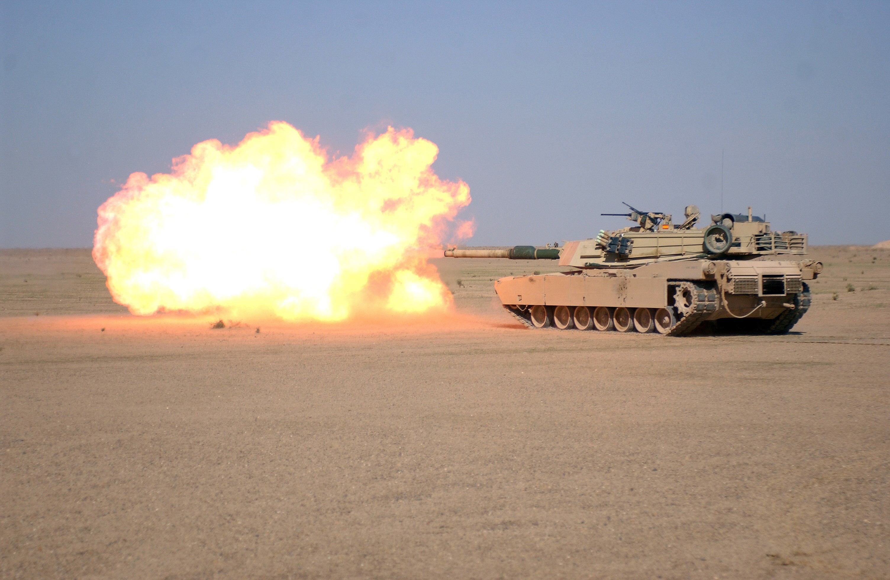 Tank firing a round in a desert HD Wallpaper