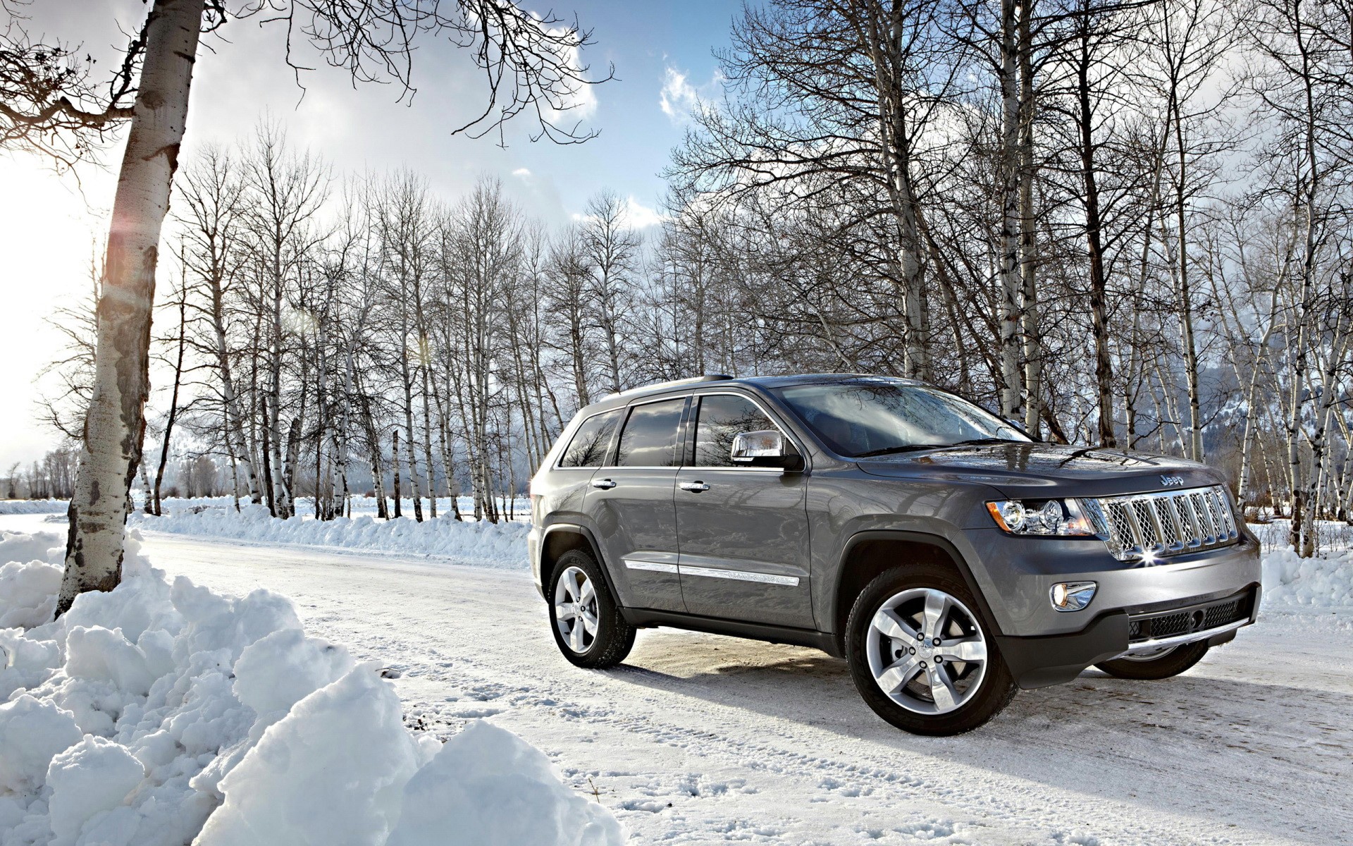 Gray Jeep Grand Cherokee on a Snowy Road HD Wallpaper