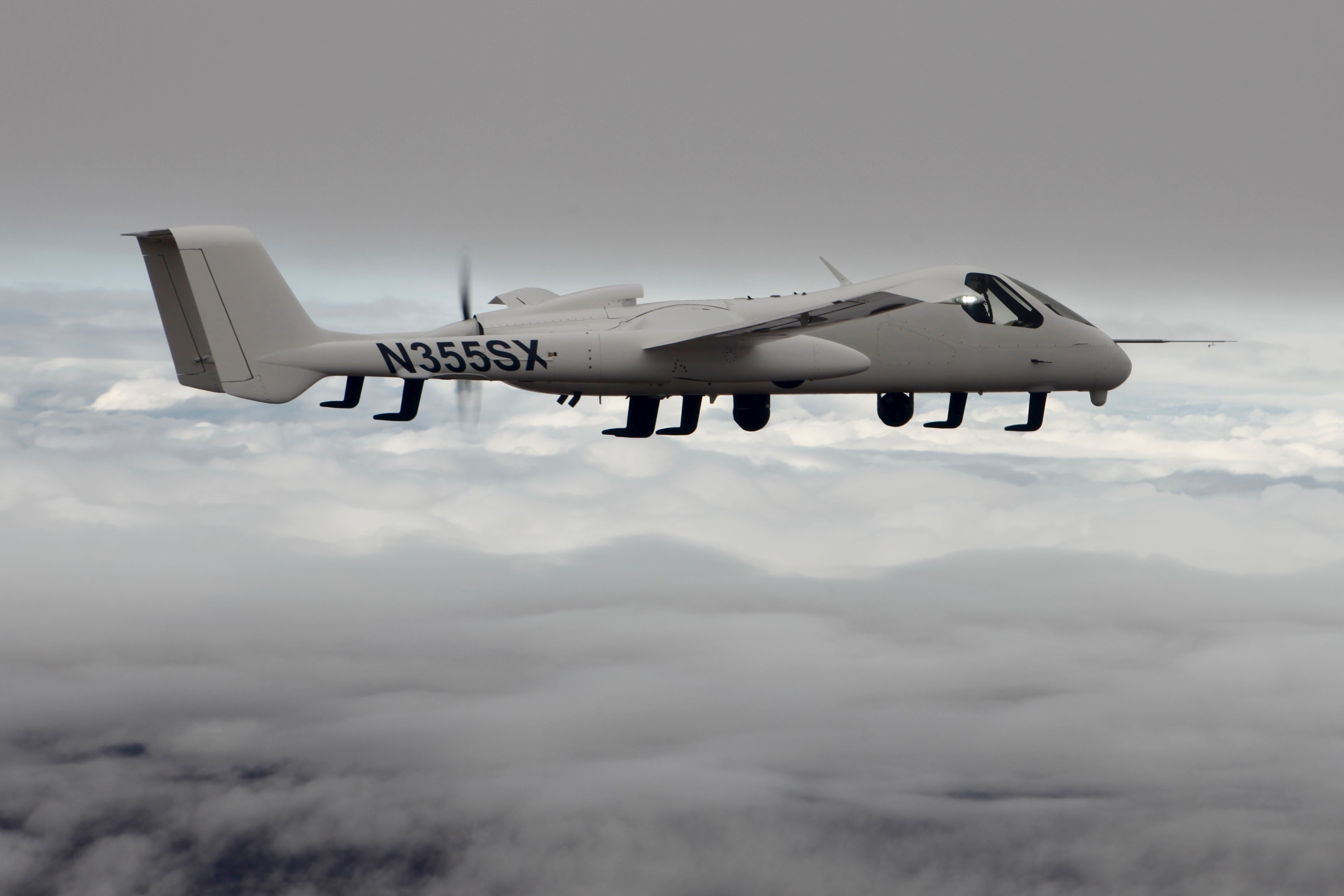 White twin-engine aircraft N355SX flying above clouds HD Wallpaper