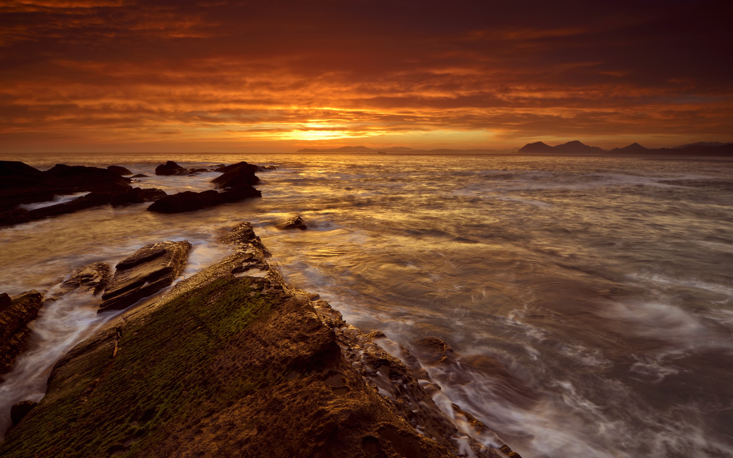 Sunset over rocky coastline with ocean waves HD Wallpaper