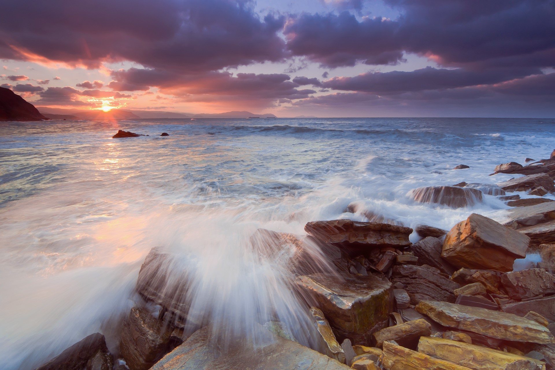 Waves crashing on rocks at sunset HD Wallpaper
