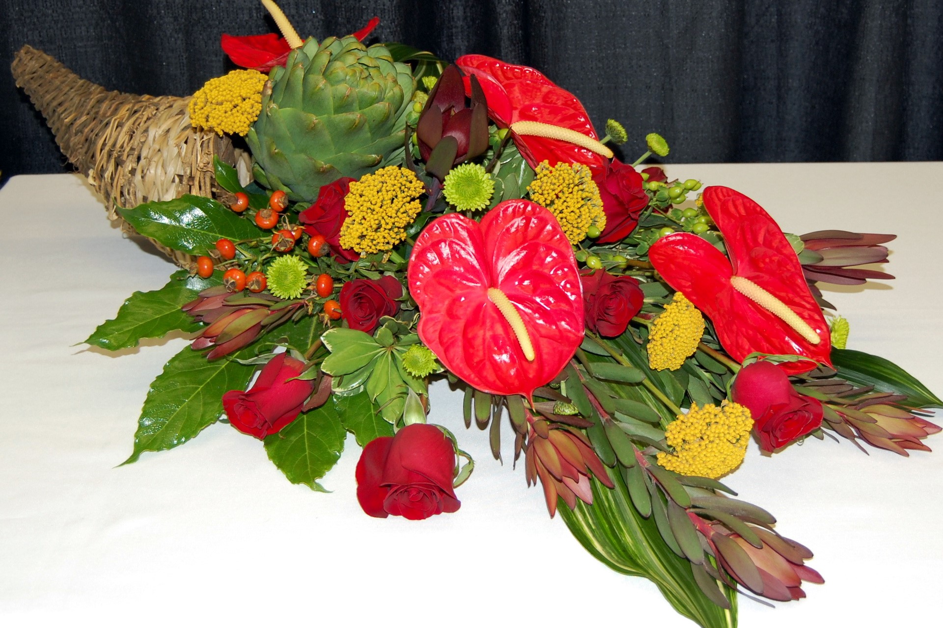 Cornucopia flower arrangement with anthuriums and roses HD Wallpaper