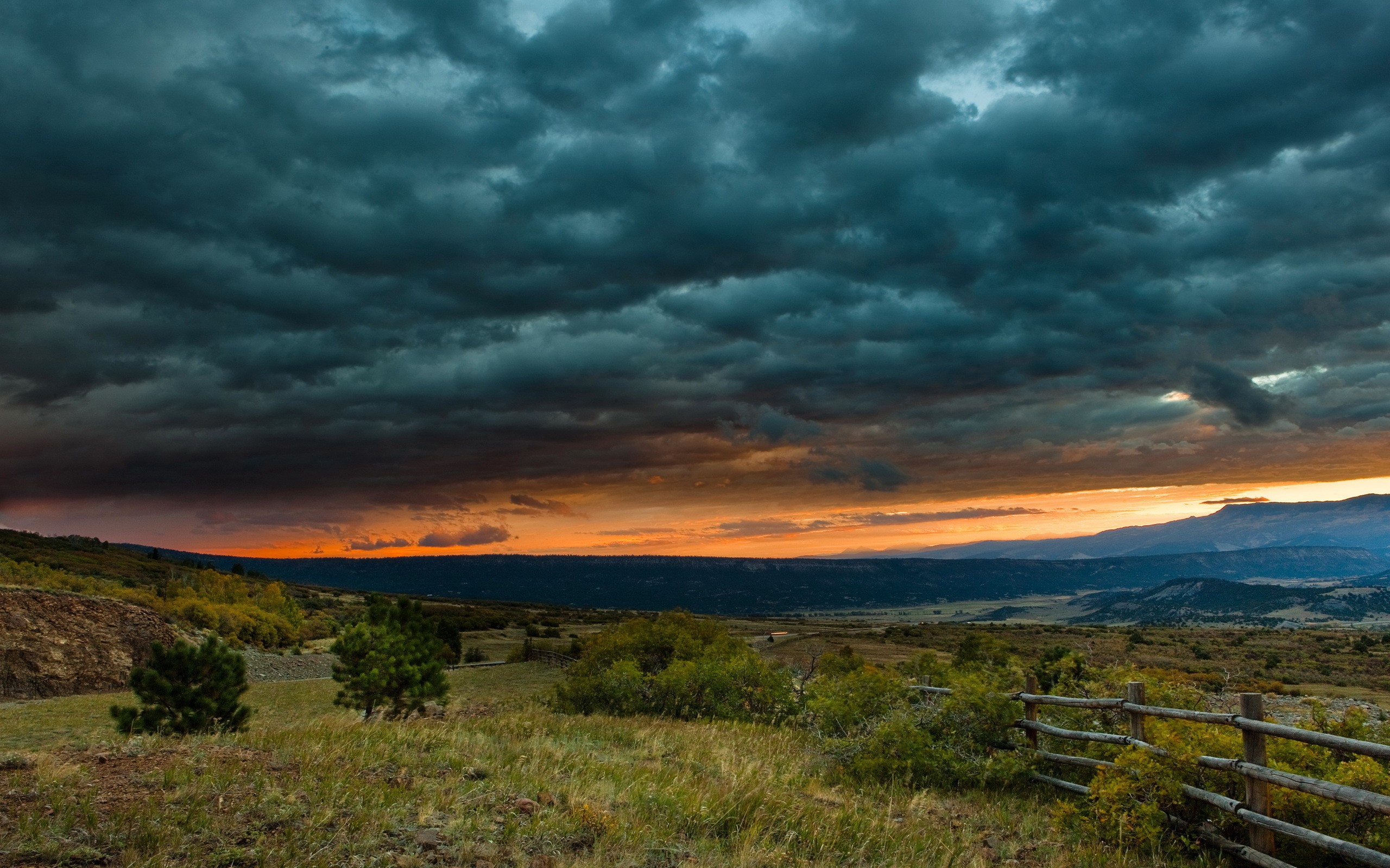 Stormy Sunset Over a Rural Landscape HD Wallpaper