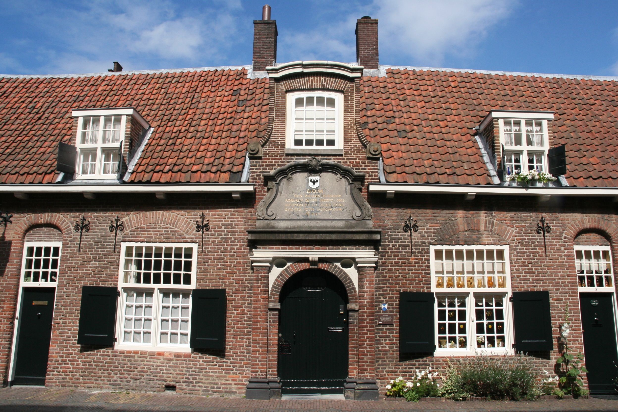 Brick building with red tiled roof in Utrecht, Netherlands HD Wallpaper