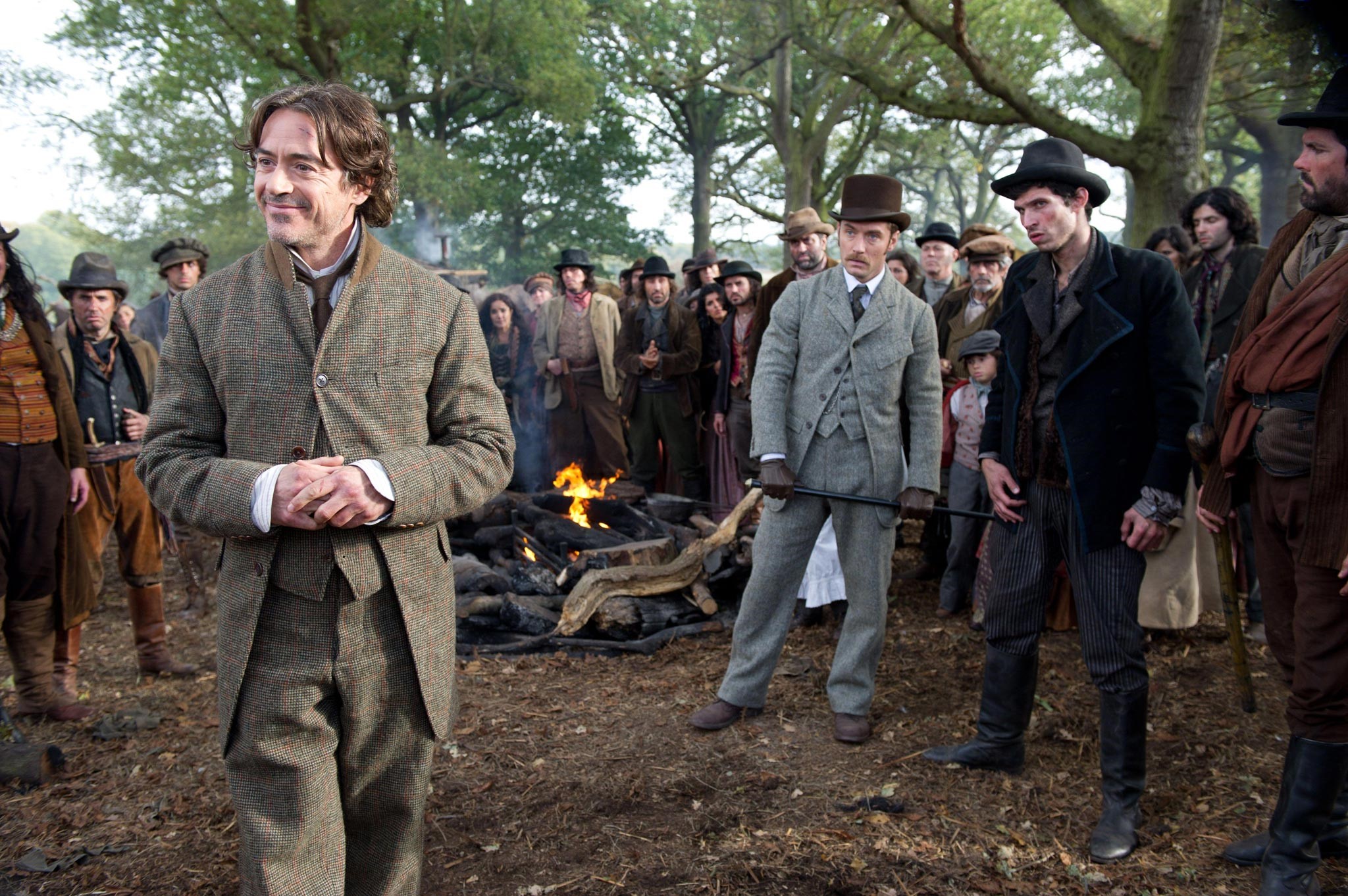Sherlock Holmes and a crowd gathered around a bonfire HD Wallpaper