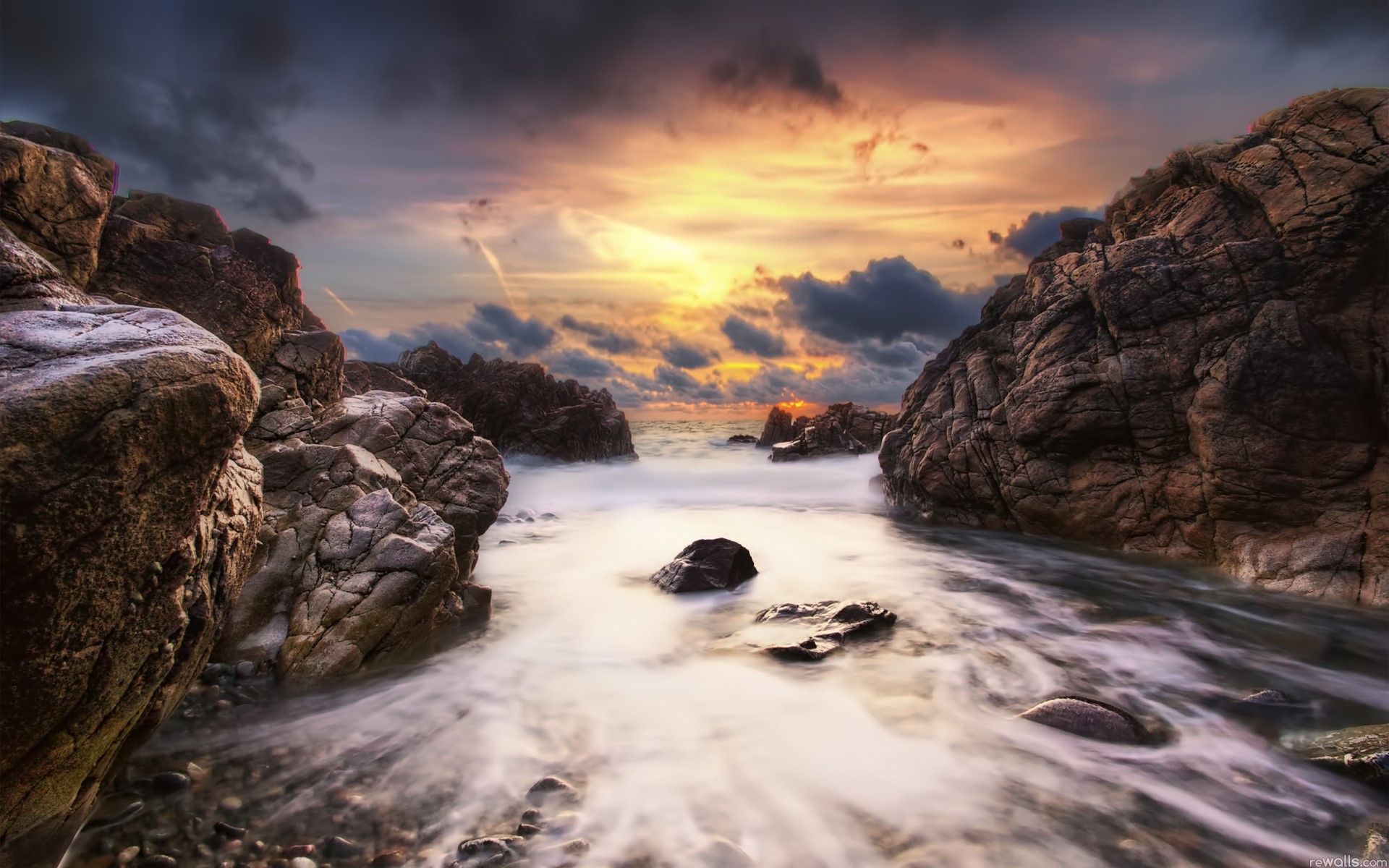 Rocky coastline at sunset with dramatic clouds HD Wallpaper