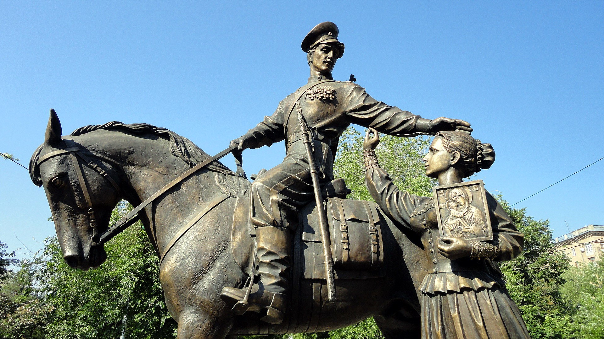 Monument of a soldier on horseback with a woman holding an icon HD Wallpaper