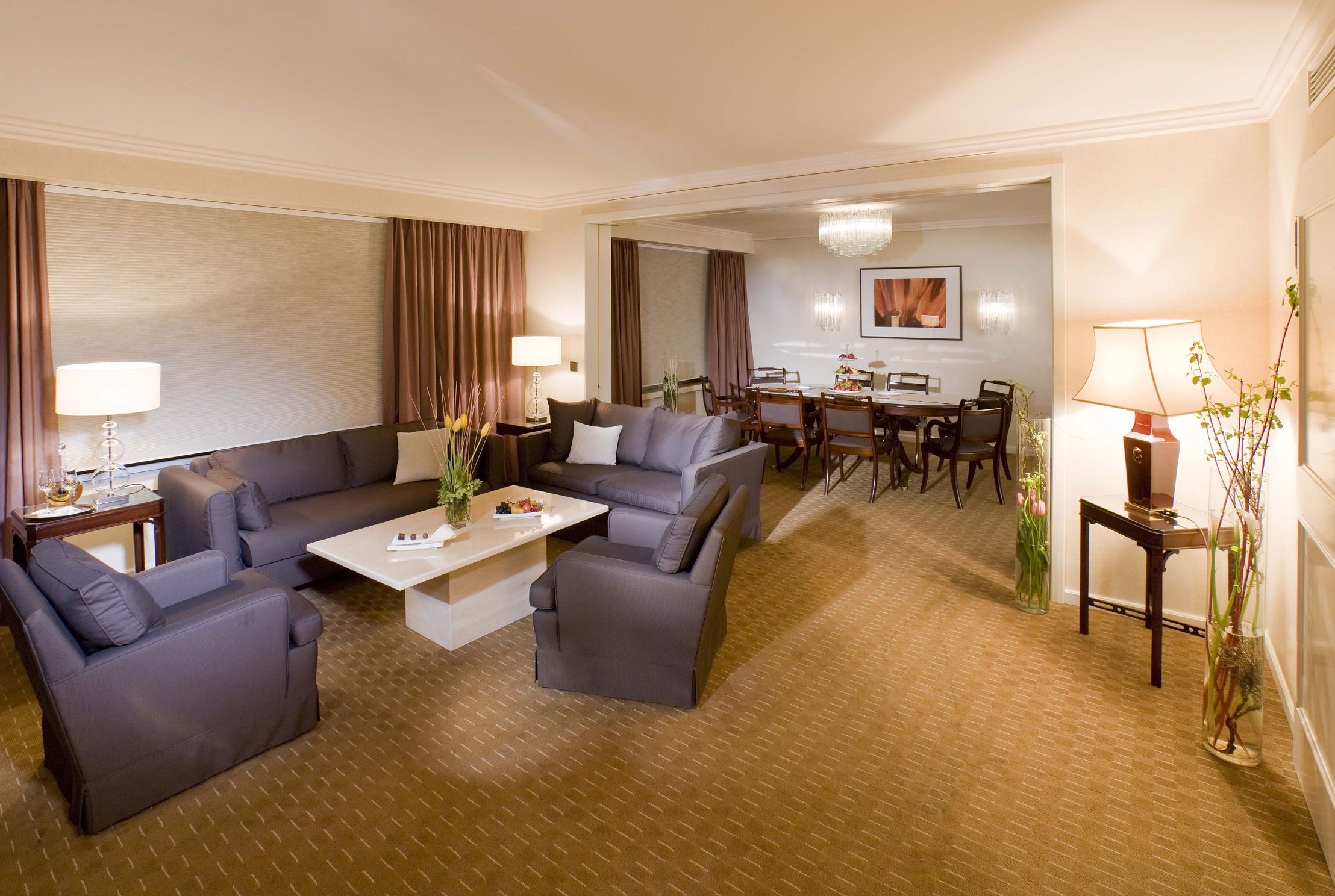 Living room and dining room in a hotel suite HD Wallpaper