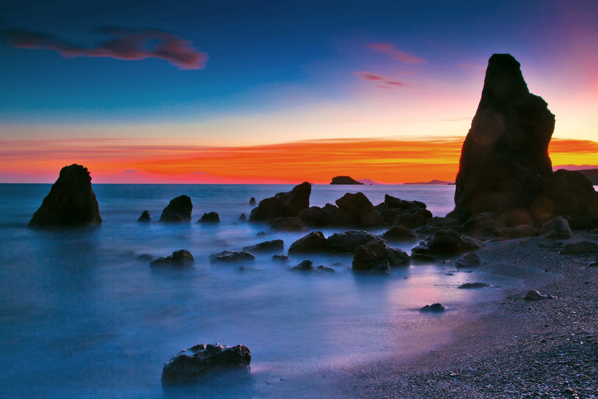 Rocky coastline at sunset with colorful sky HD Wallpaper